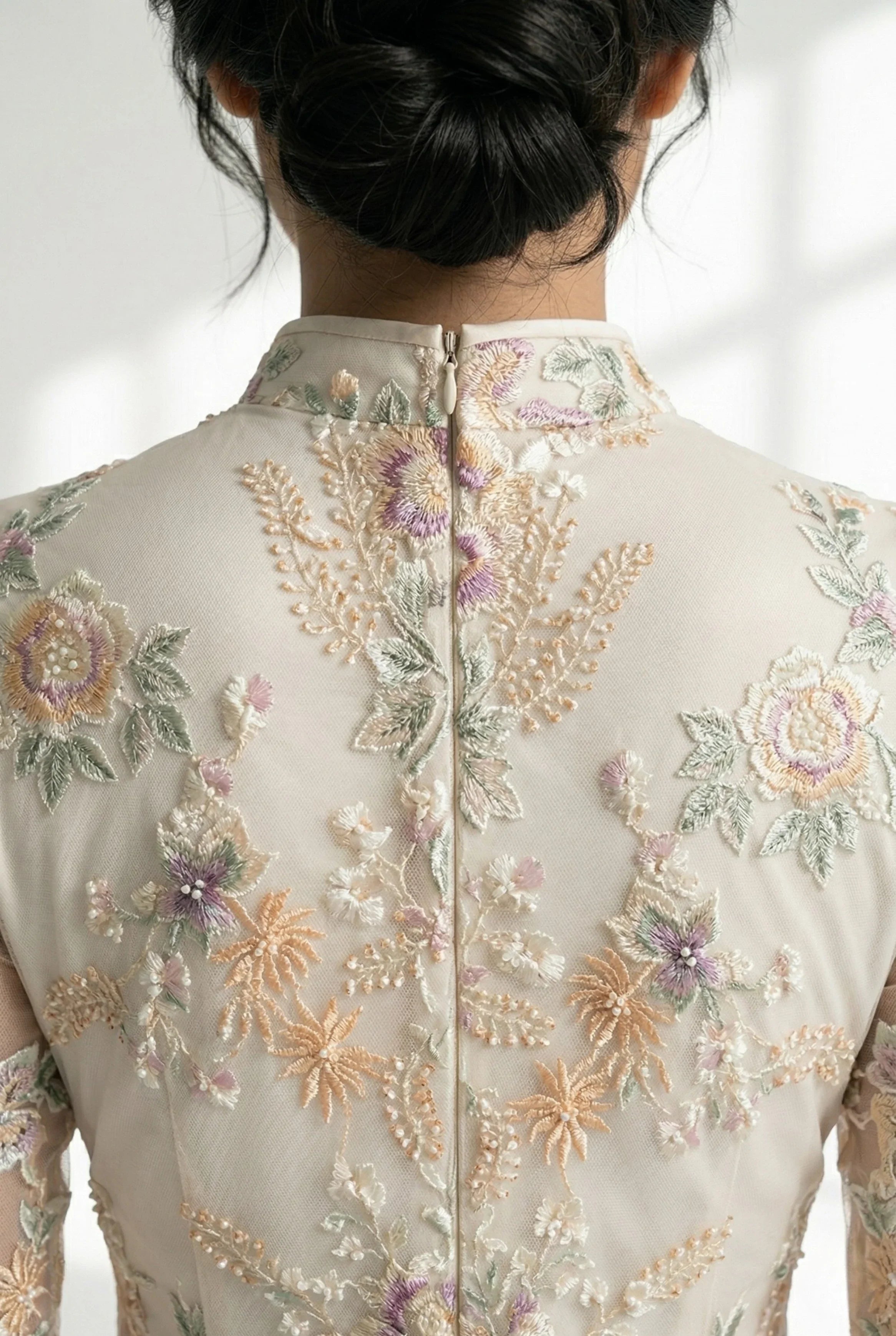 Close-up of the mandarin collar and back zipper of the beige Chinese dress.
