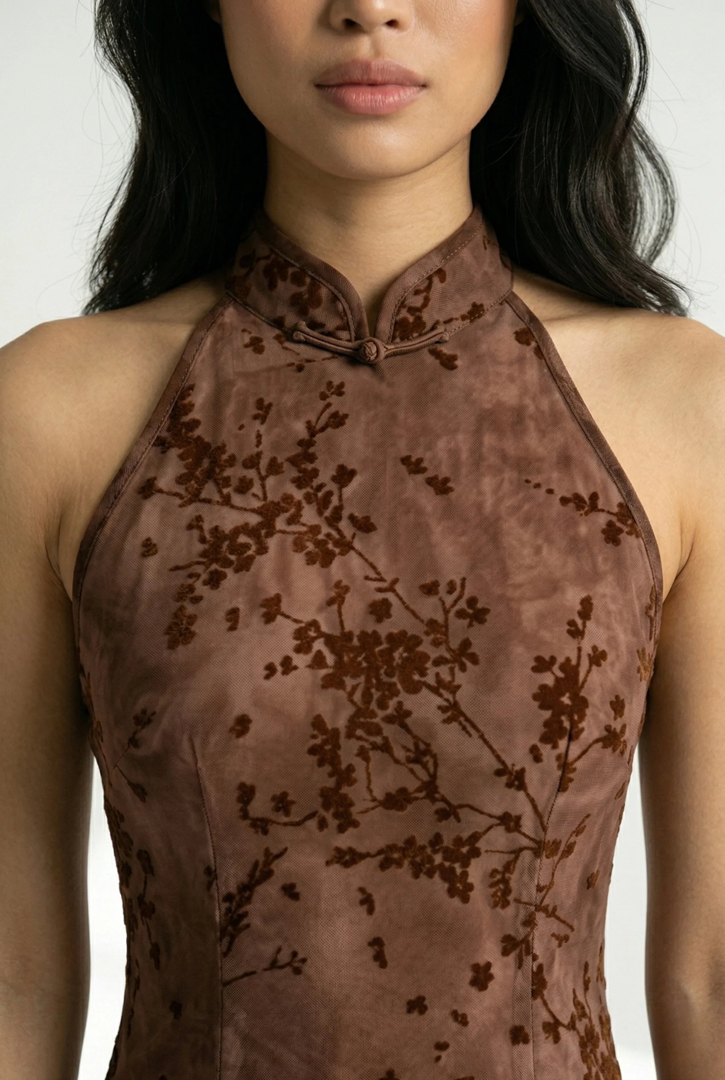 Close-up of the mandarin collar on a brown Chinese dress.