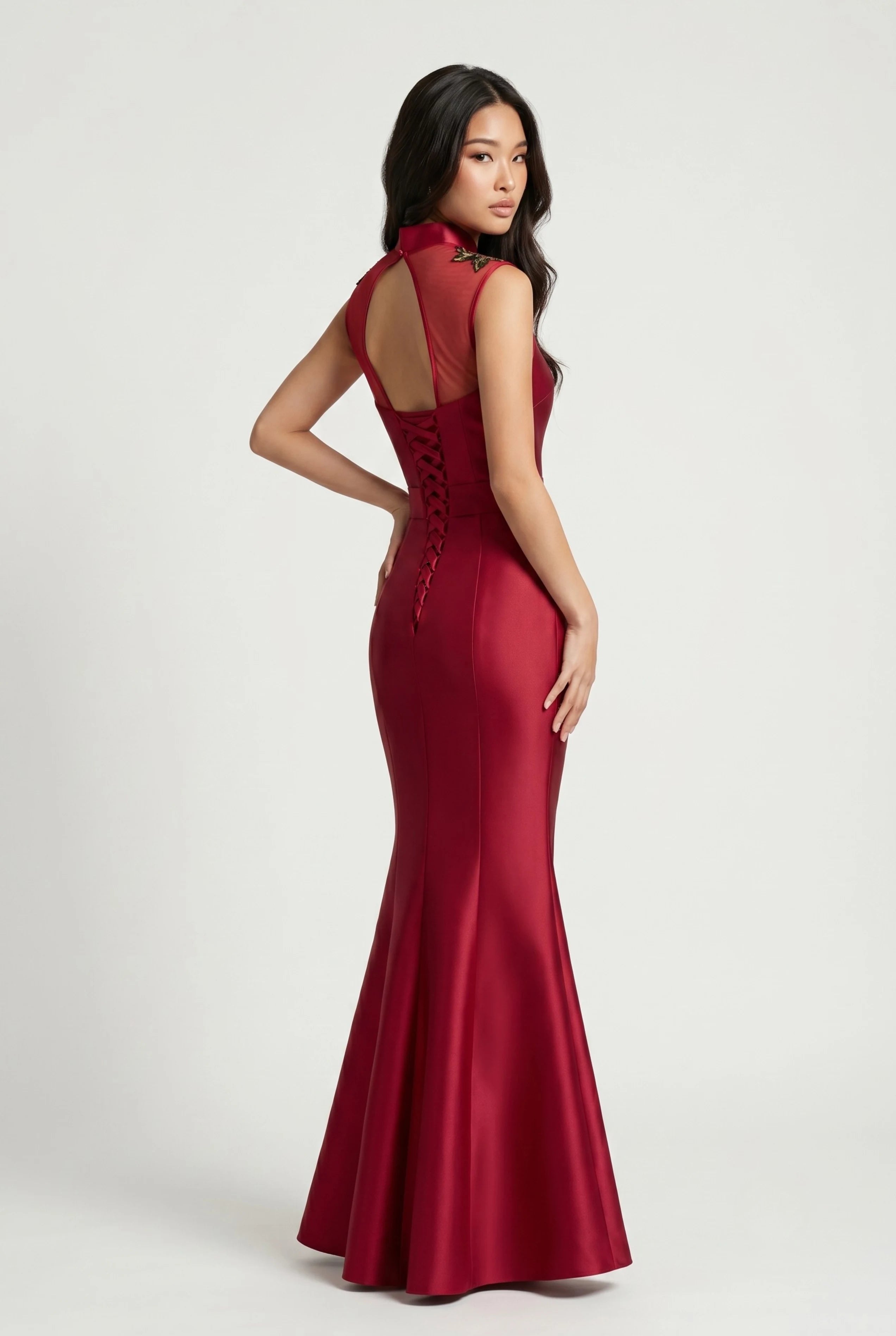 Full-length back view of the wine red mermaid qipao showcasing the dramatic flared skirt and sheer keyhole back