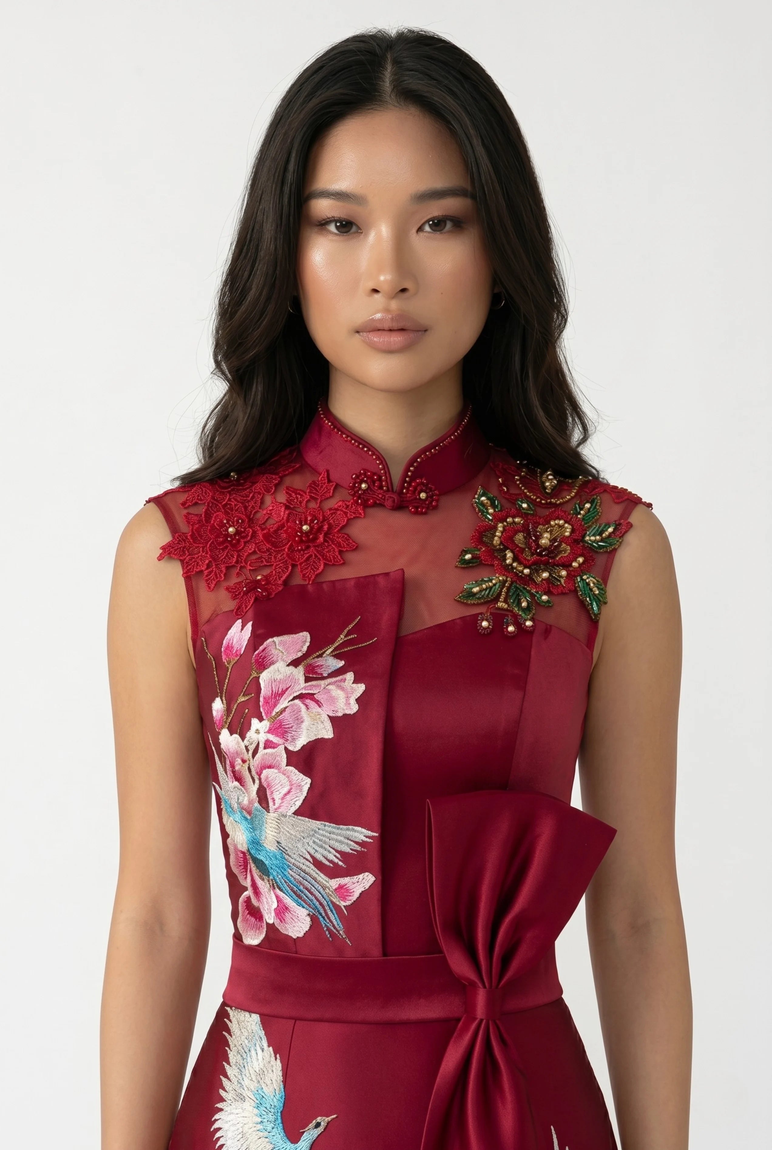 Close-up front view highlighting the sheer lace neckline, mandarin collar, crane embroidery, and structured satin bow