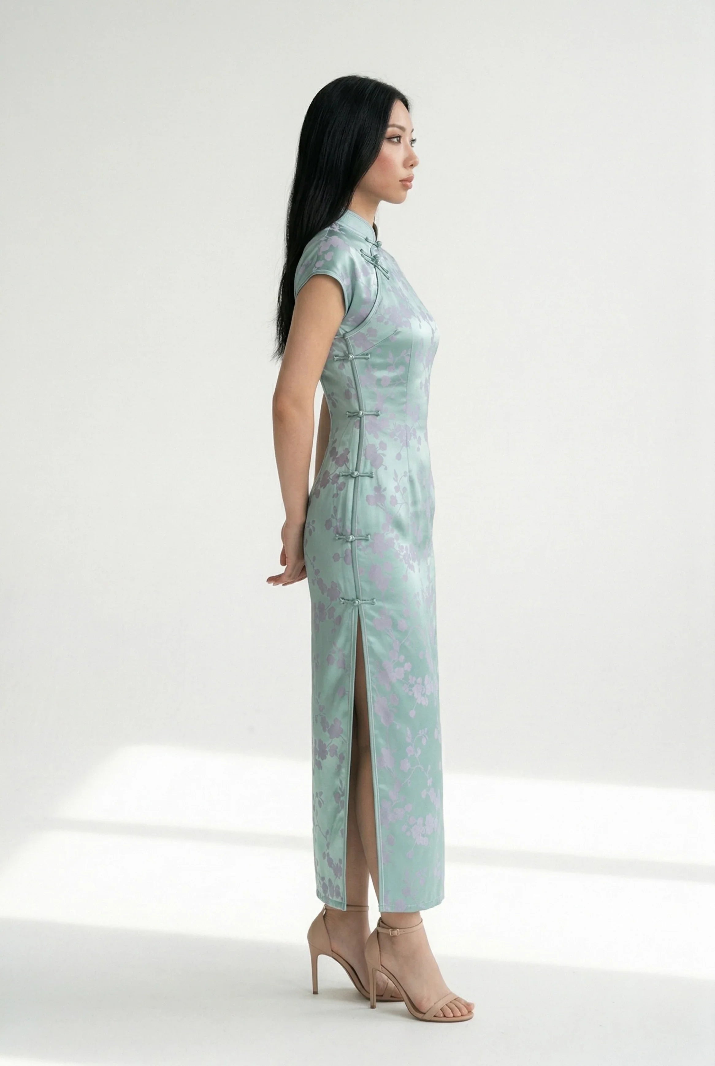 Side view profile of the mint-green floral qipao, showing high leg slit.