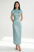 Front view of a long, mint-green qipao with lavender floral jacquard.