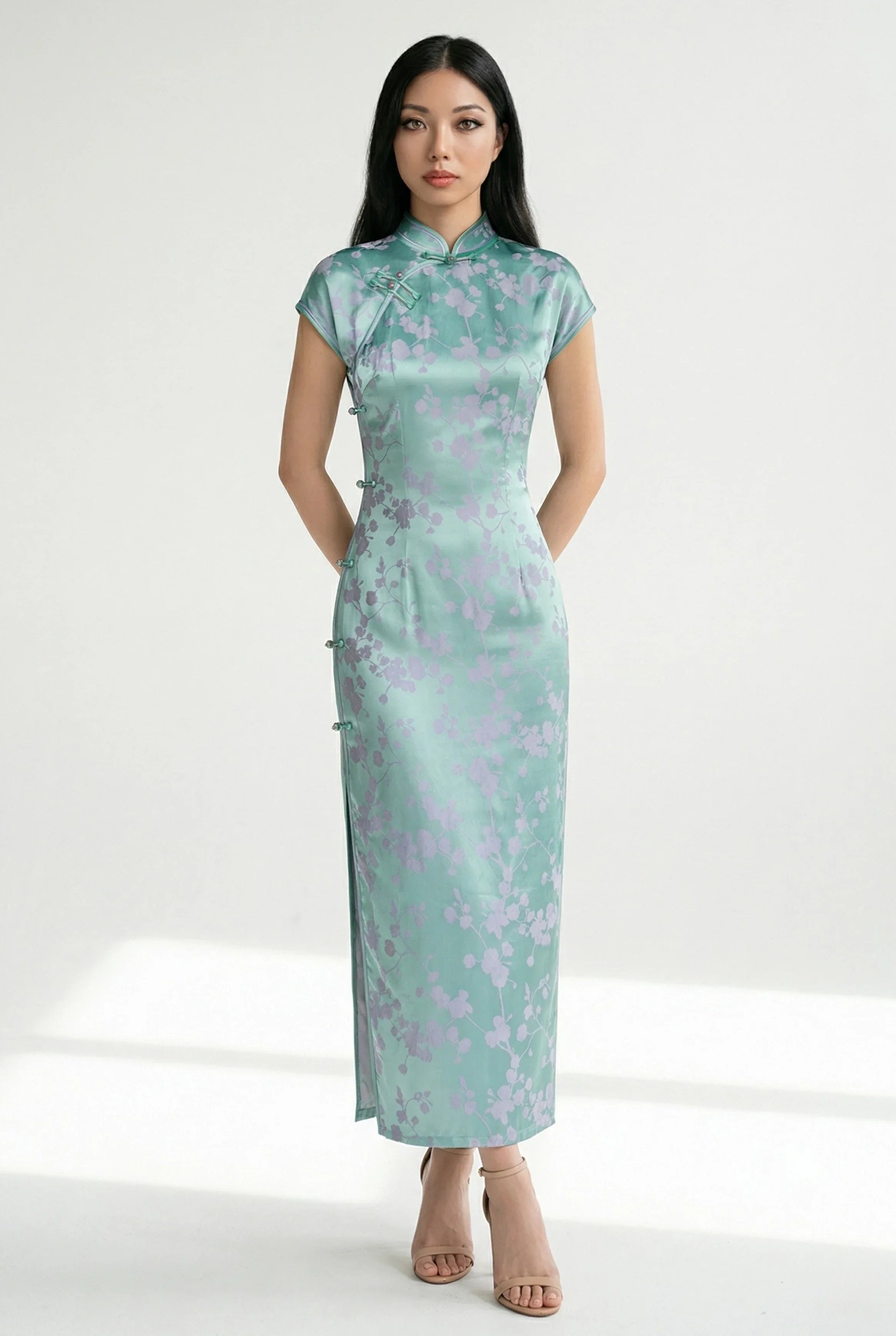 Front view of a long, mint-green qipao with lavender floral jacquard.