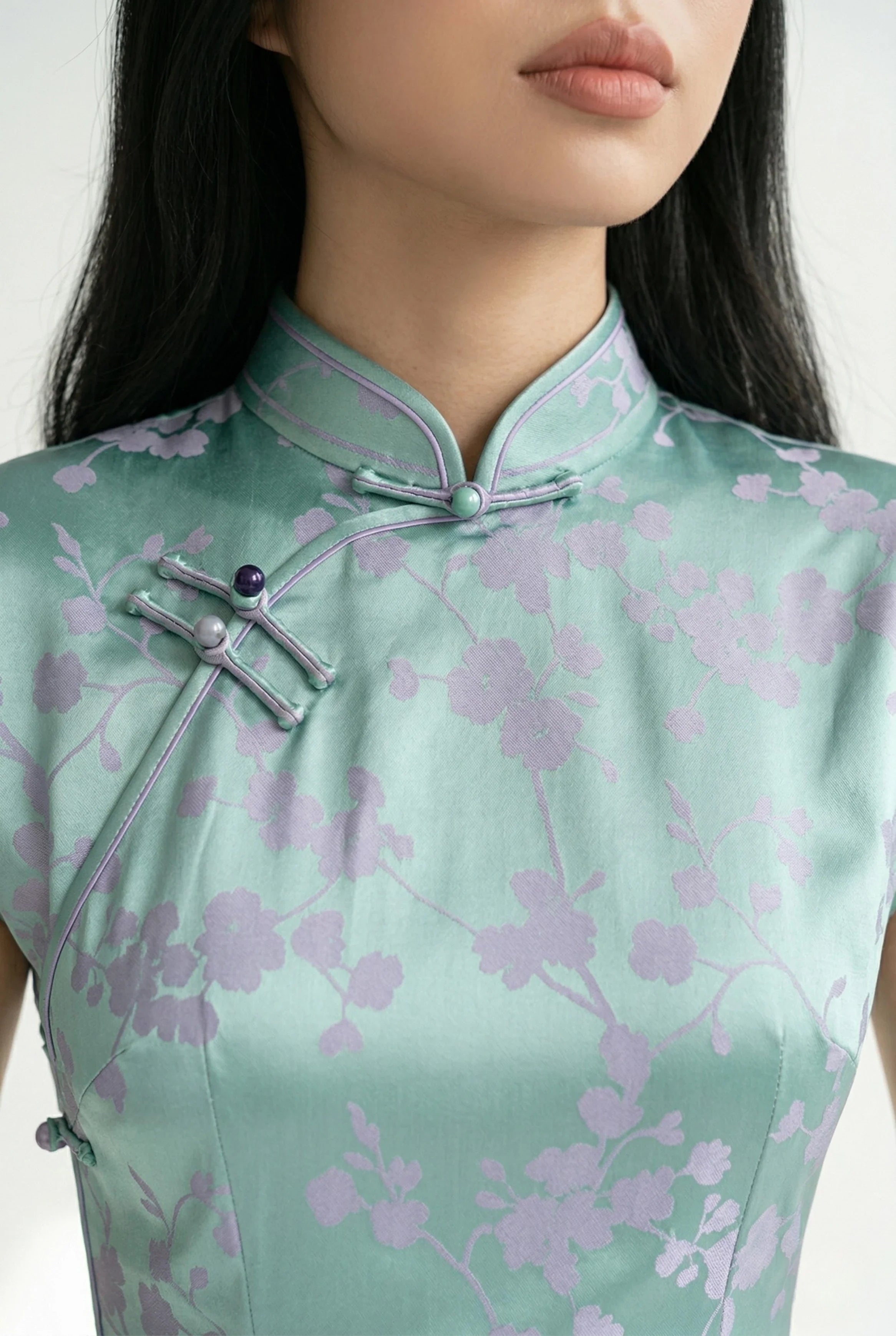 Close-up of the mandarin collar and matching frog button on the mint qipao.