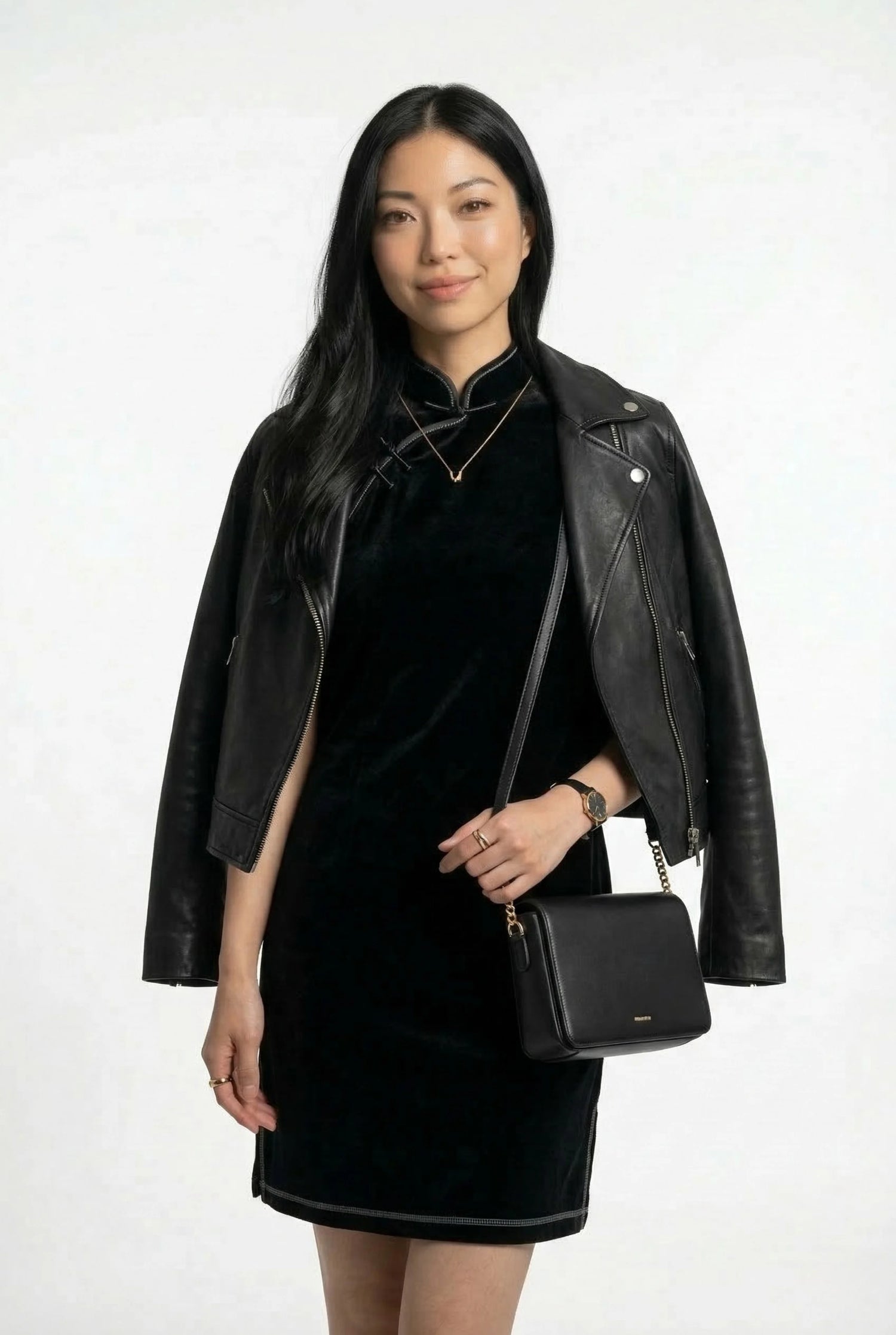 Modern black velvet qipao dress styled with a leather jacket and shoulder bag for a contemporary versatile look