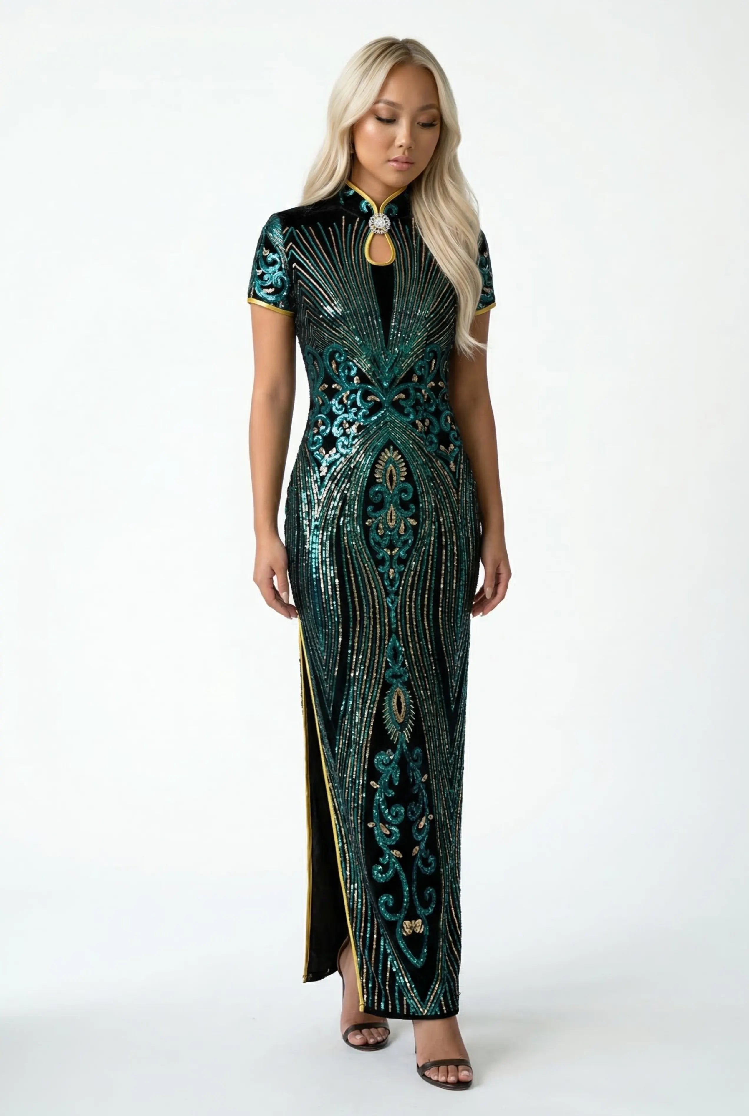 Full-length front view of a model wearing a modern dark green midi Qipao dress with blue and green floral patterns.