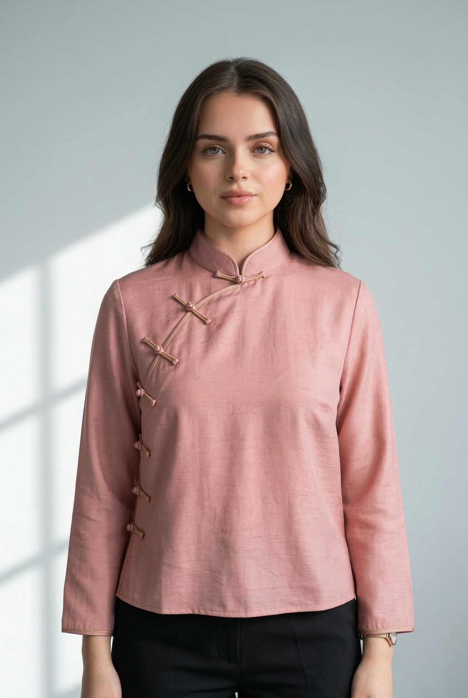 Modern light pink qipao top with an asymmetrical opening and Pankou buttons, styled for a professional heritage look