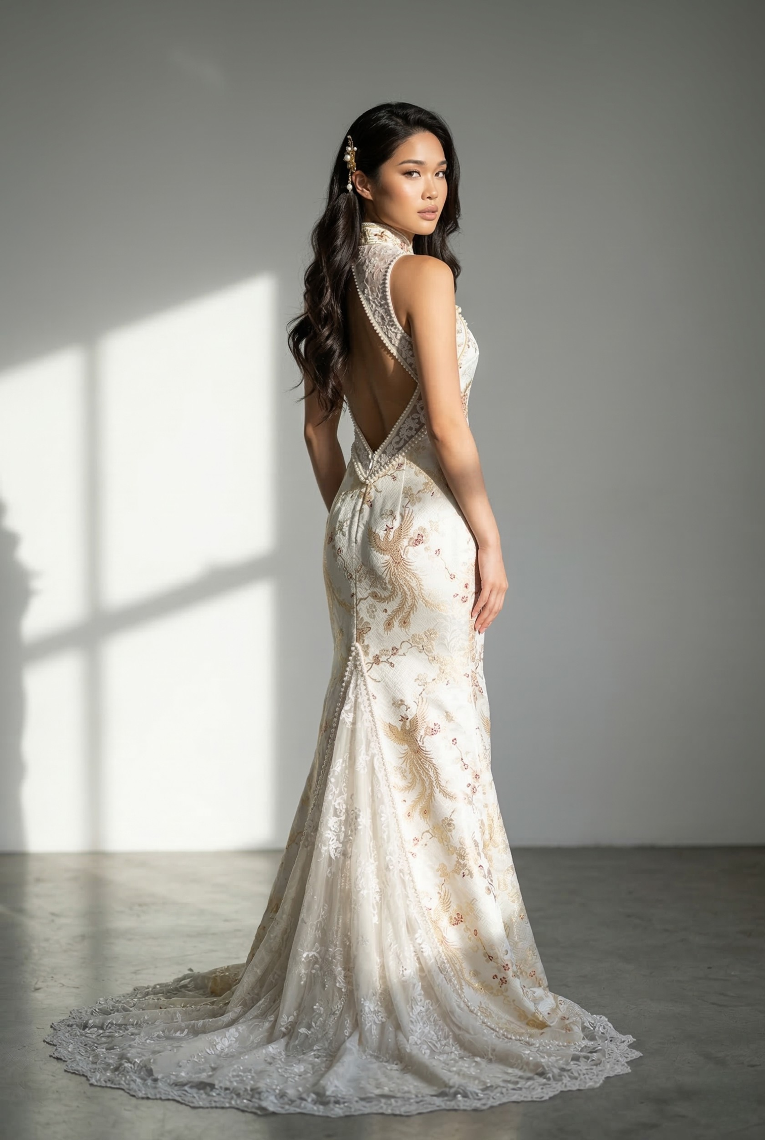 Modern white Chinese wedding dress featuring an open-back design and trailing hemline, blending Western bridal elements with a traditional Mandarin collar