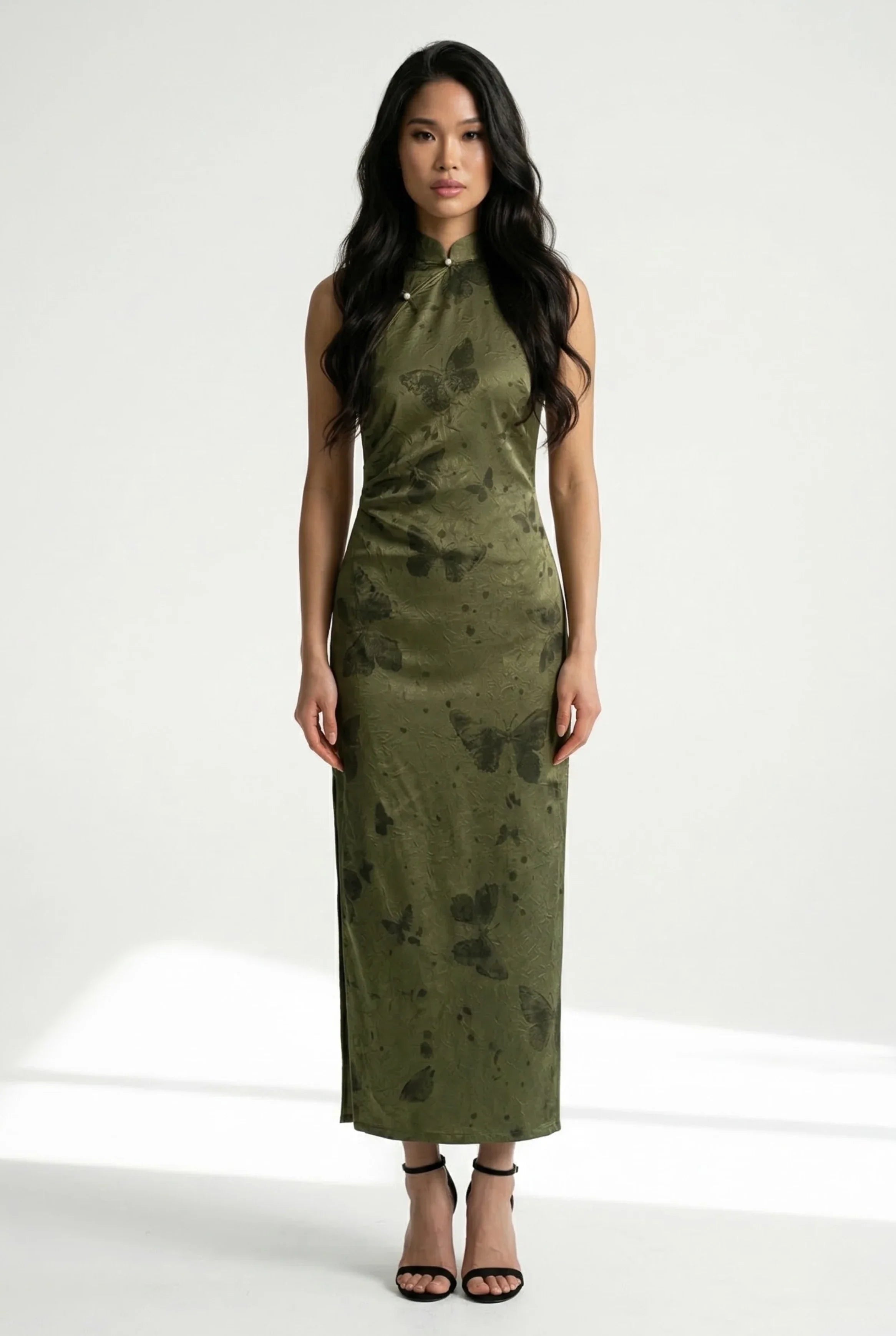 Full-length front view of an olive green Qipao dress with a sleeveless halter-neck and delicate butterfly print.