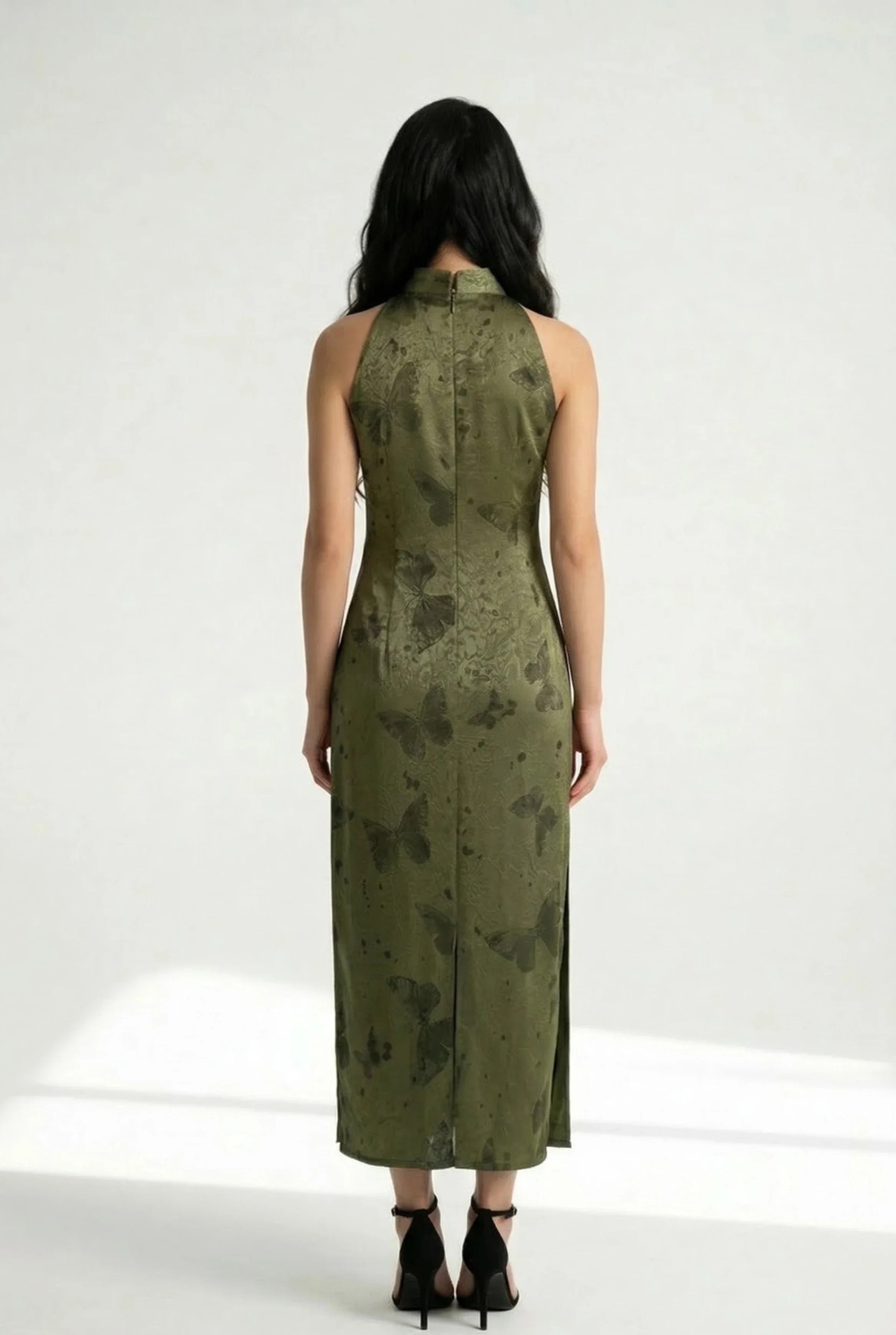 Back view of a form-fitting olive green Cheongsam dress featuring an elegant butterfly pattern and long silhouette.