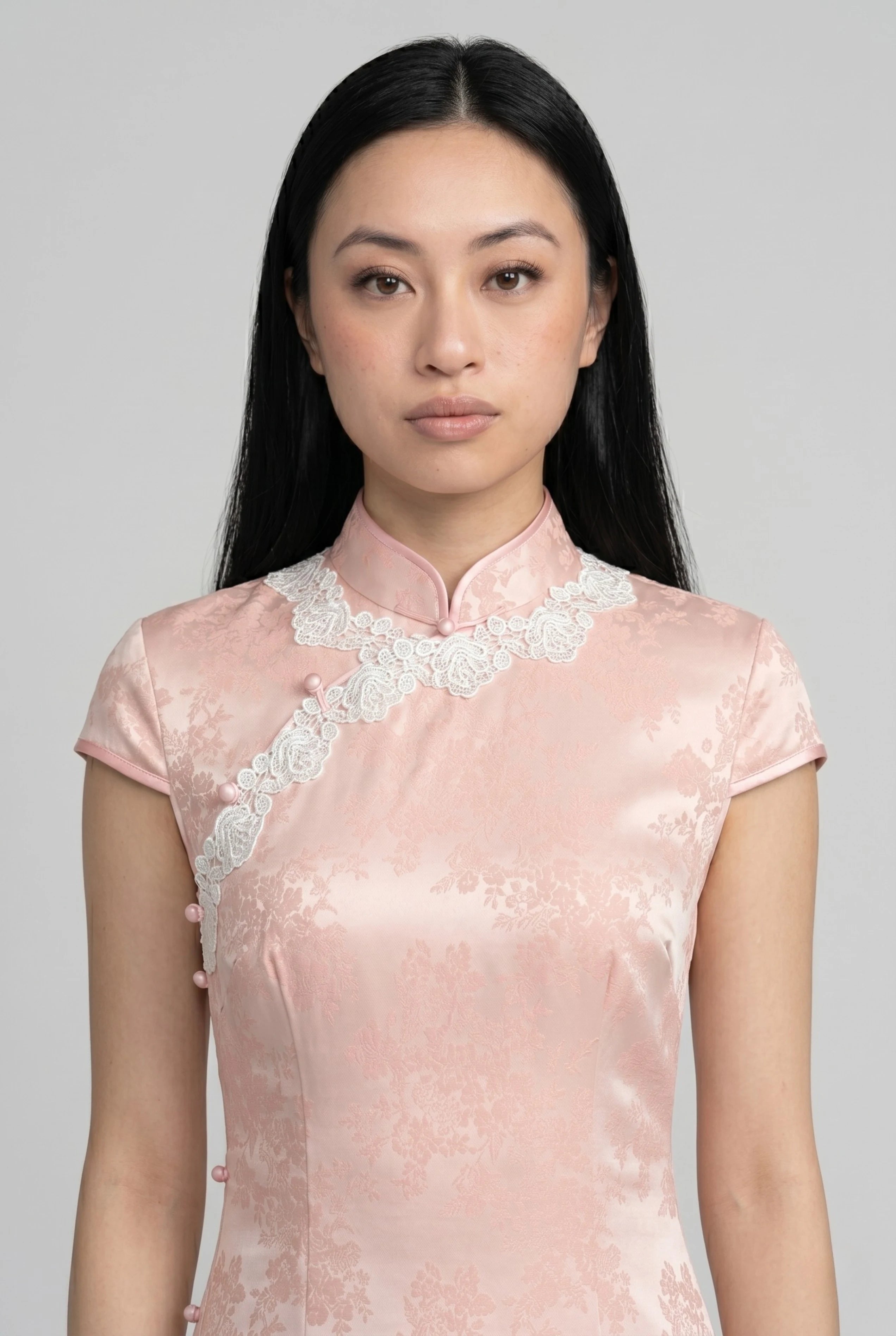 Close-up front view highlighting the high mandarin collar, asymmetrical white lace trim, and delicate fabric texture