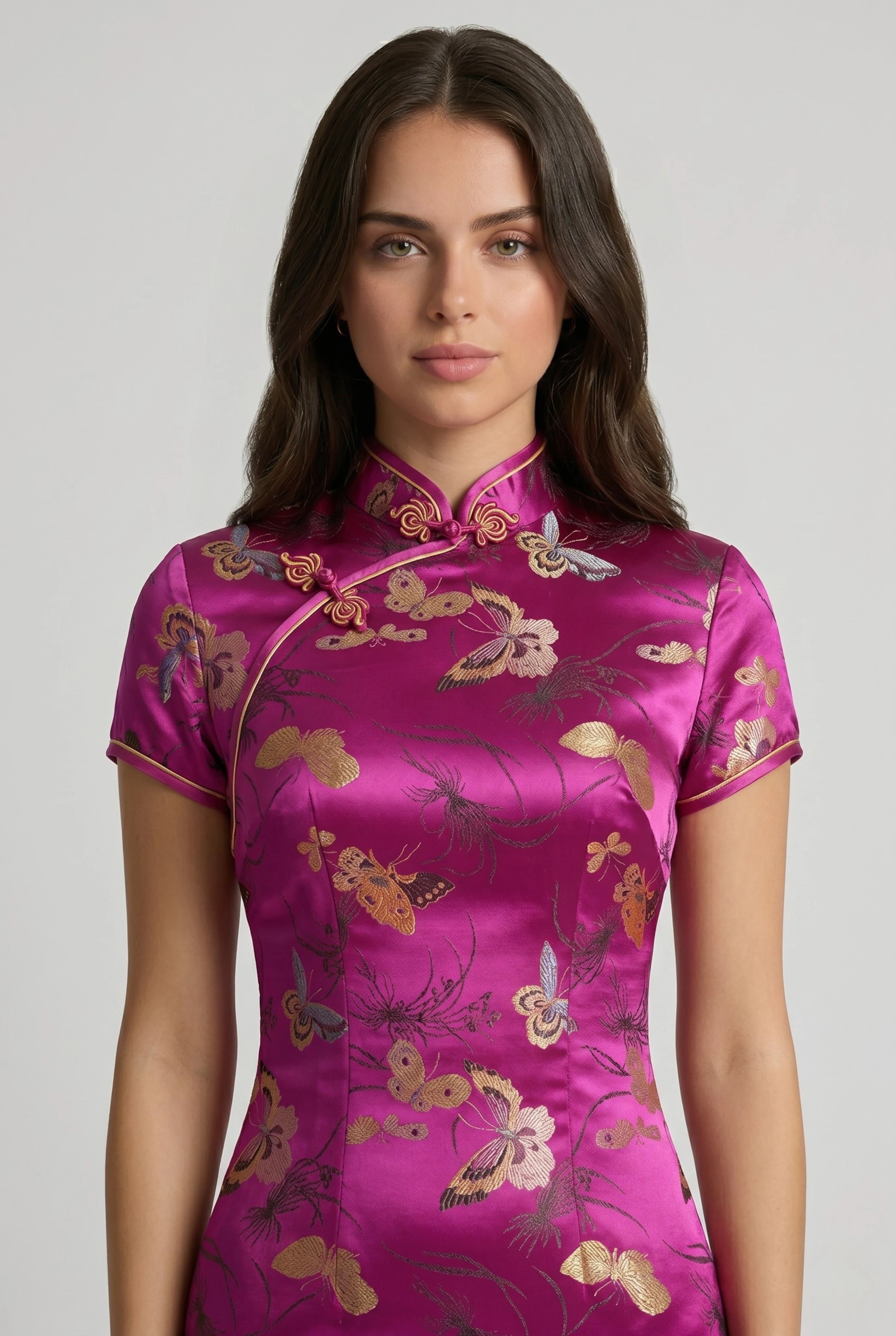 Close-up front view highlighting the high mandarin collar, asymmetrical frog closures, and gold dragon patterns on the pink bodice