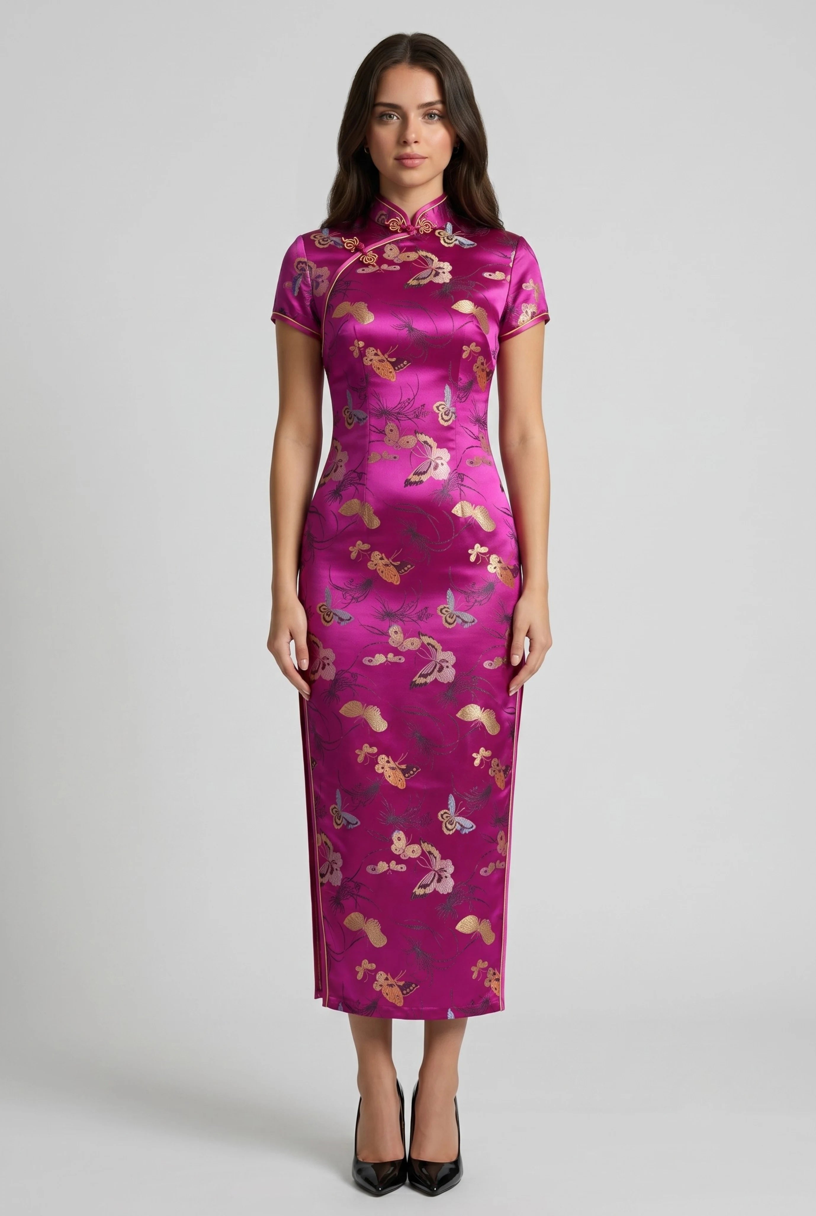 Front full-length view of a hot pink Chinese traditional dress featuring a golden brocade pattern and short cap sleeves, paired with black heels