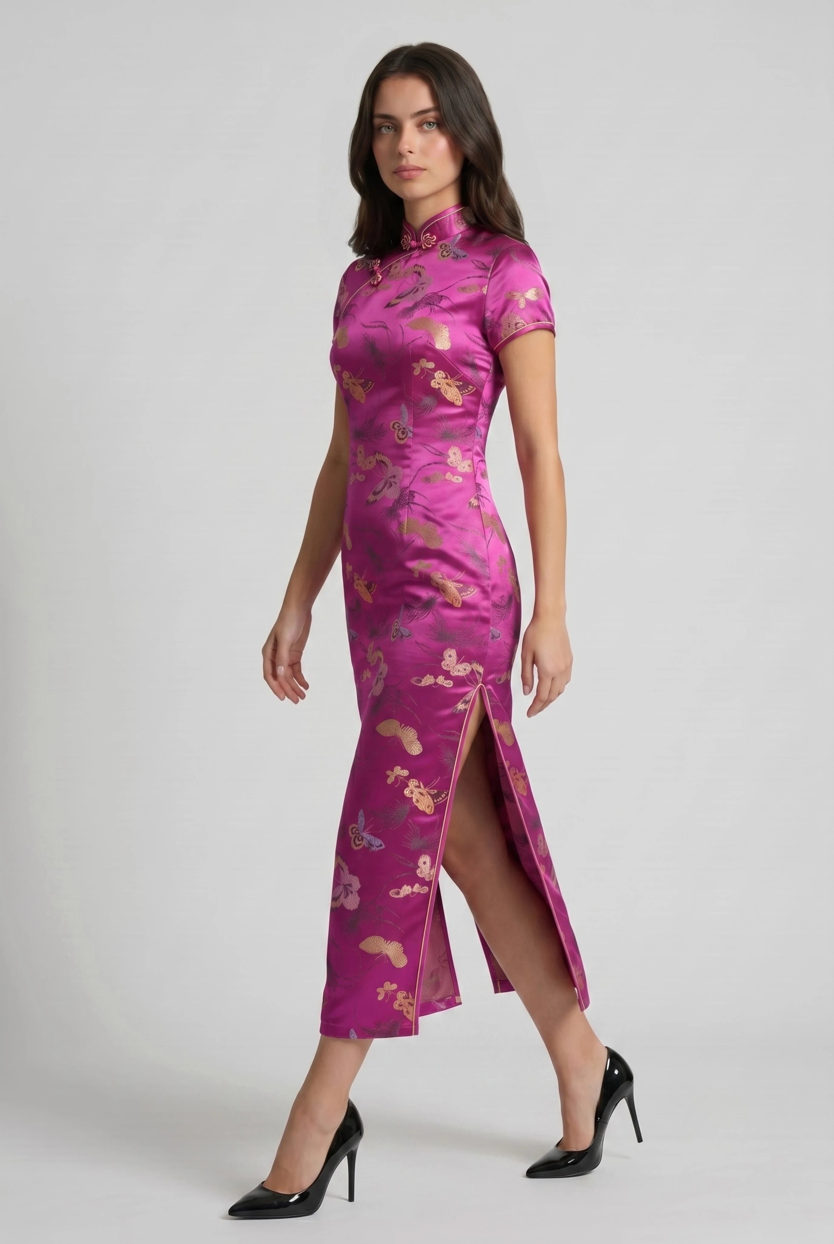 Side profile view of a woman walking in the pink traditional Chinese dress, showcasing the high side slit