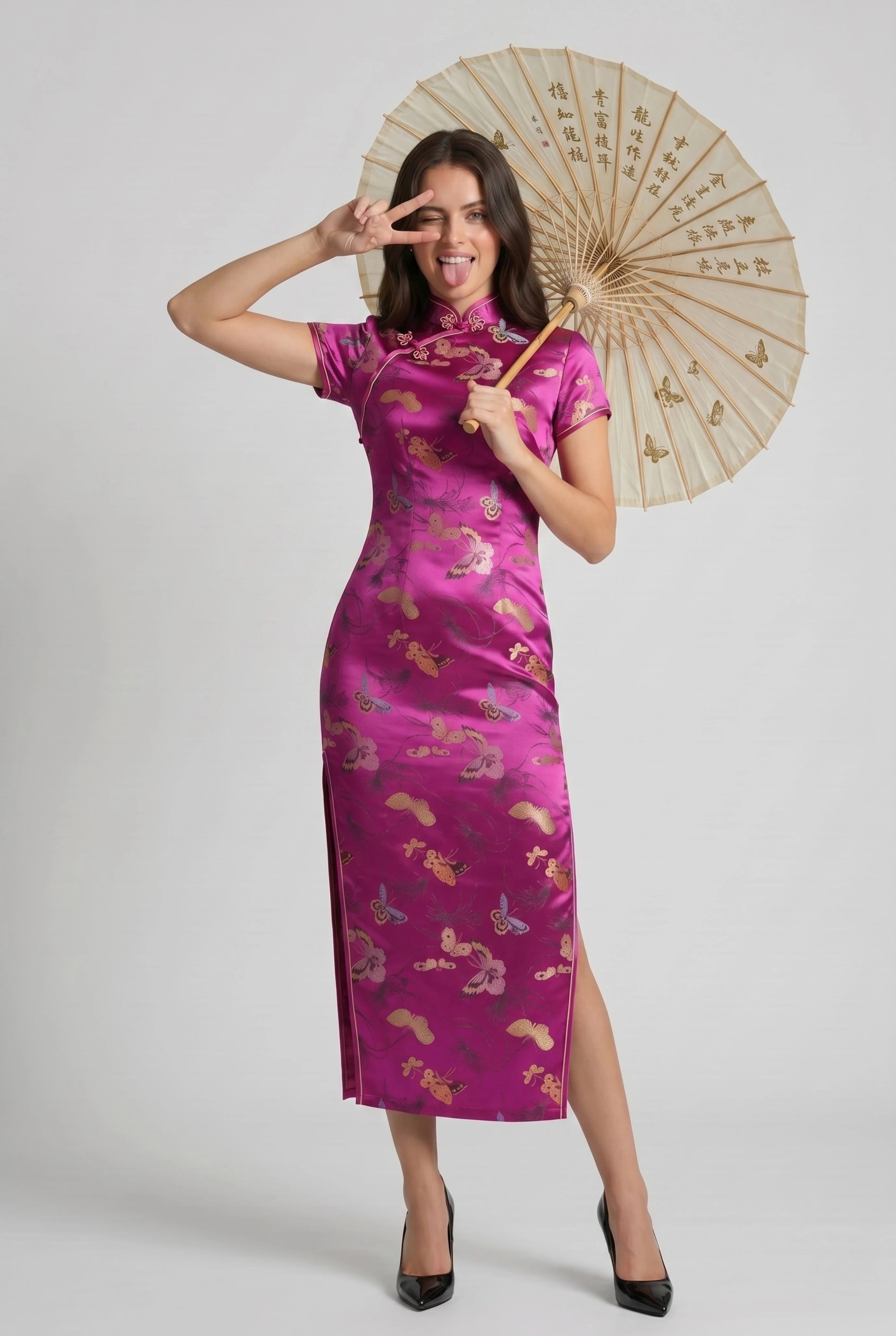 Full-length front view of a woman posing with a traditional oil-paper parasol while wearing the pink qipao dress