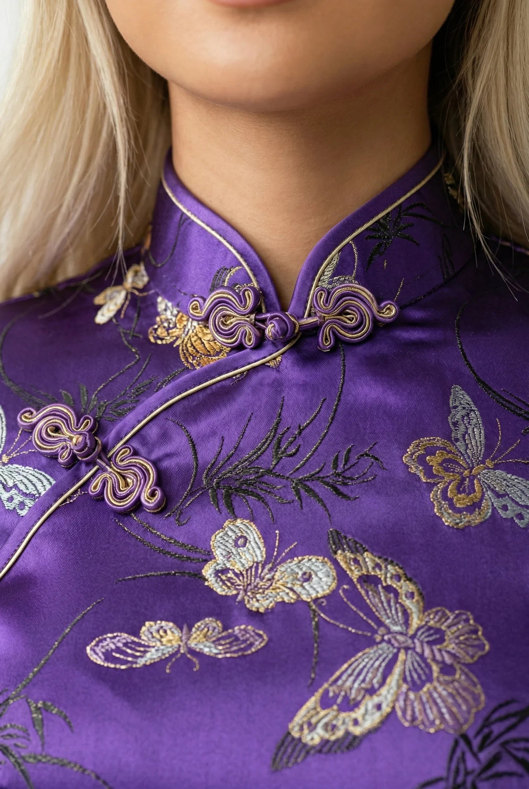 Maison Hua purple qipao detail, mandarin collar and gold butterflies