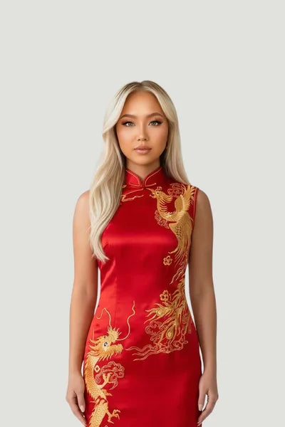 A model wearing a vibrant red silk sleeveless qipao by Maison Hua, featuring intricate gold embroidery and a traditional Mandarin collar