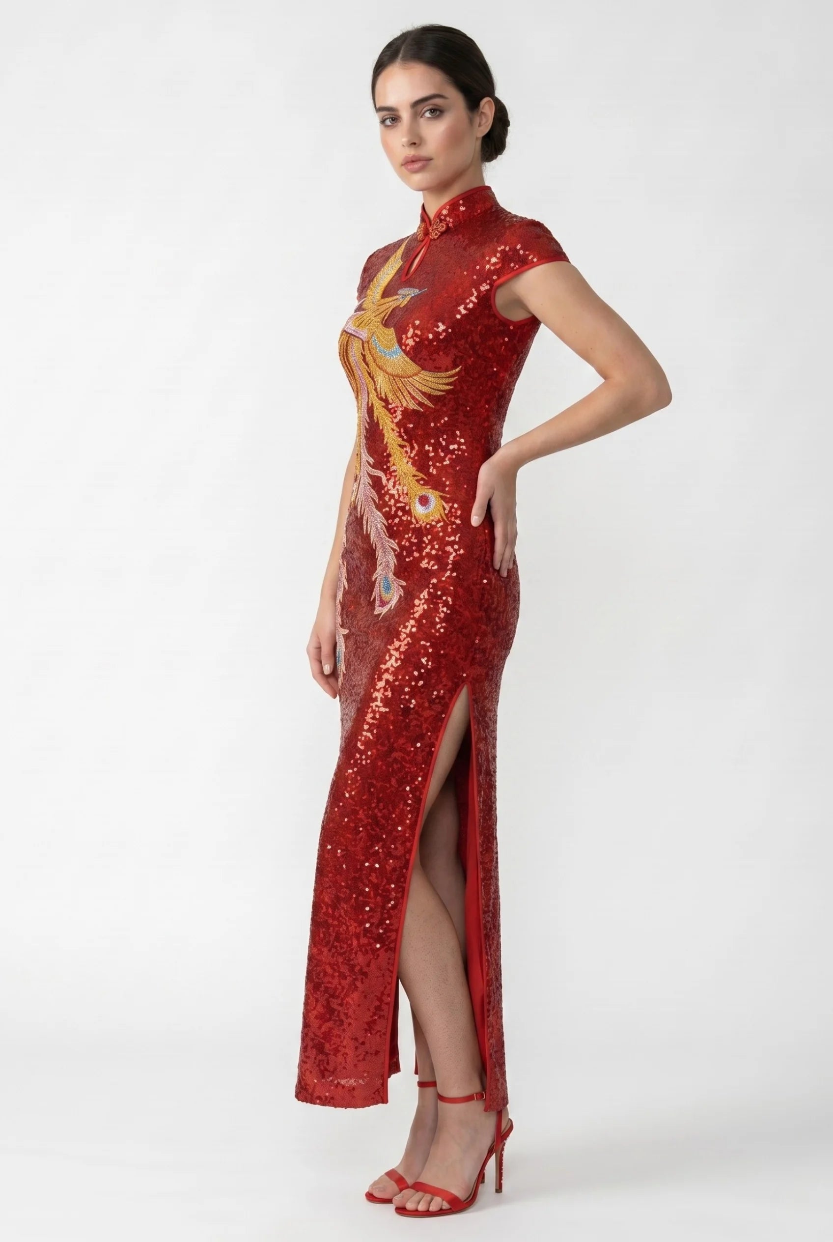 Side profile view of a woman posing in the sequin phoenix cheongsam, showcasing the high side slit