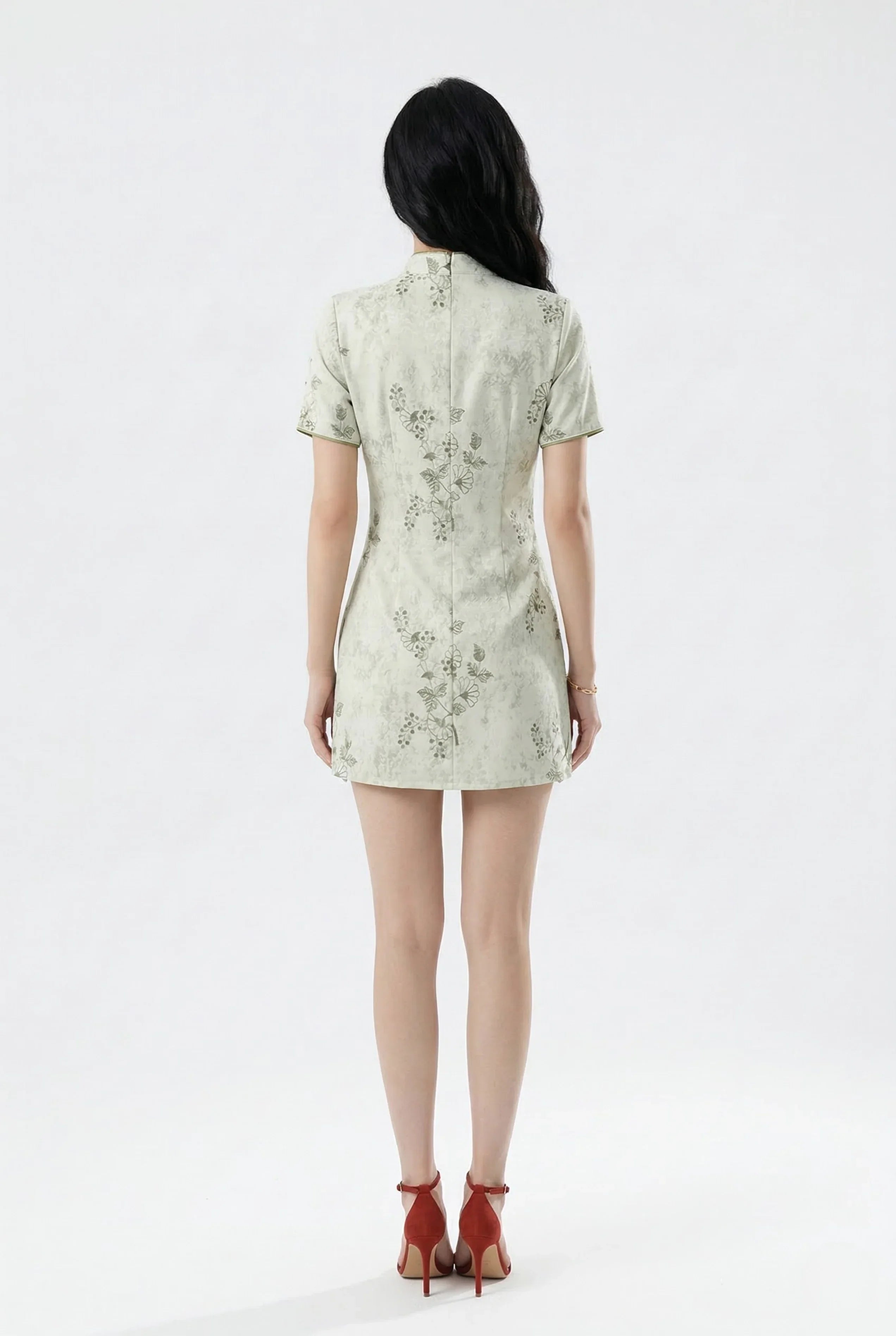 Back view of the short light green cheongsam showing the slim fit.