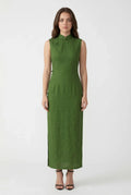 A woman wearing a simple and elegant sleeveless green linen qipao maxi dress with traditional frog button closures.