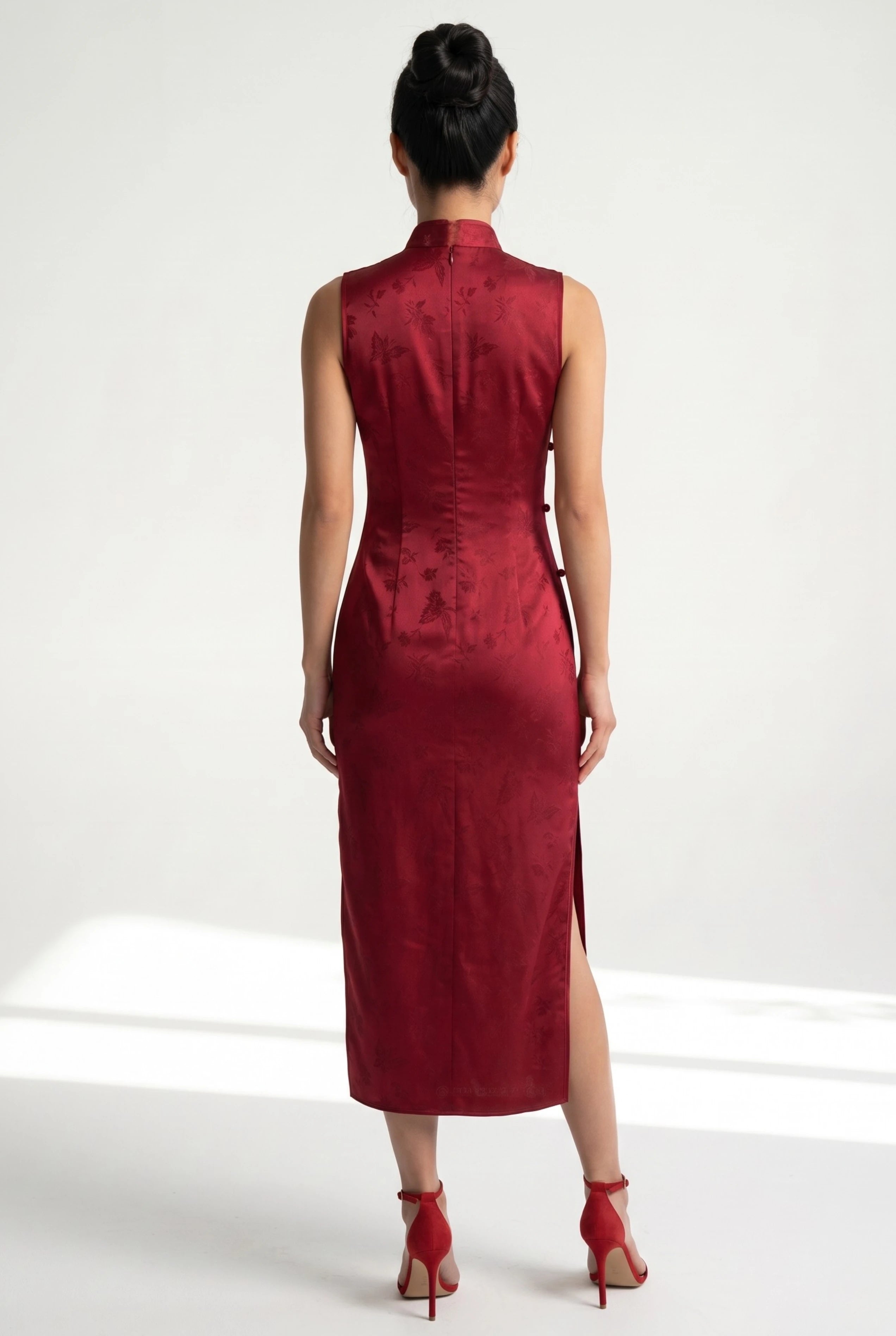 Back view of the sleeveless red cheongsam showing the sleek, form-fitting silhouette