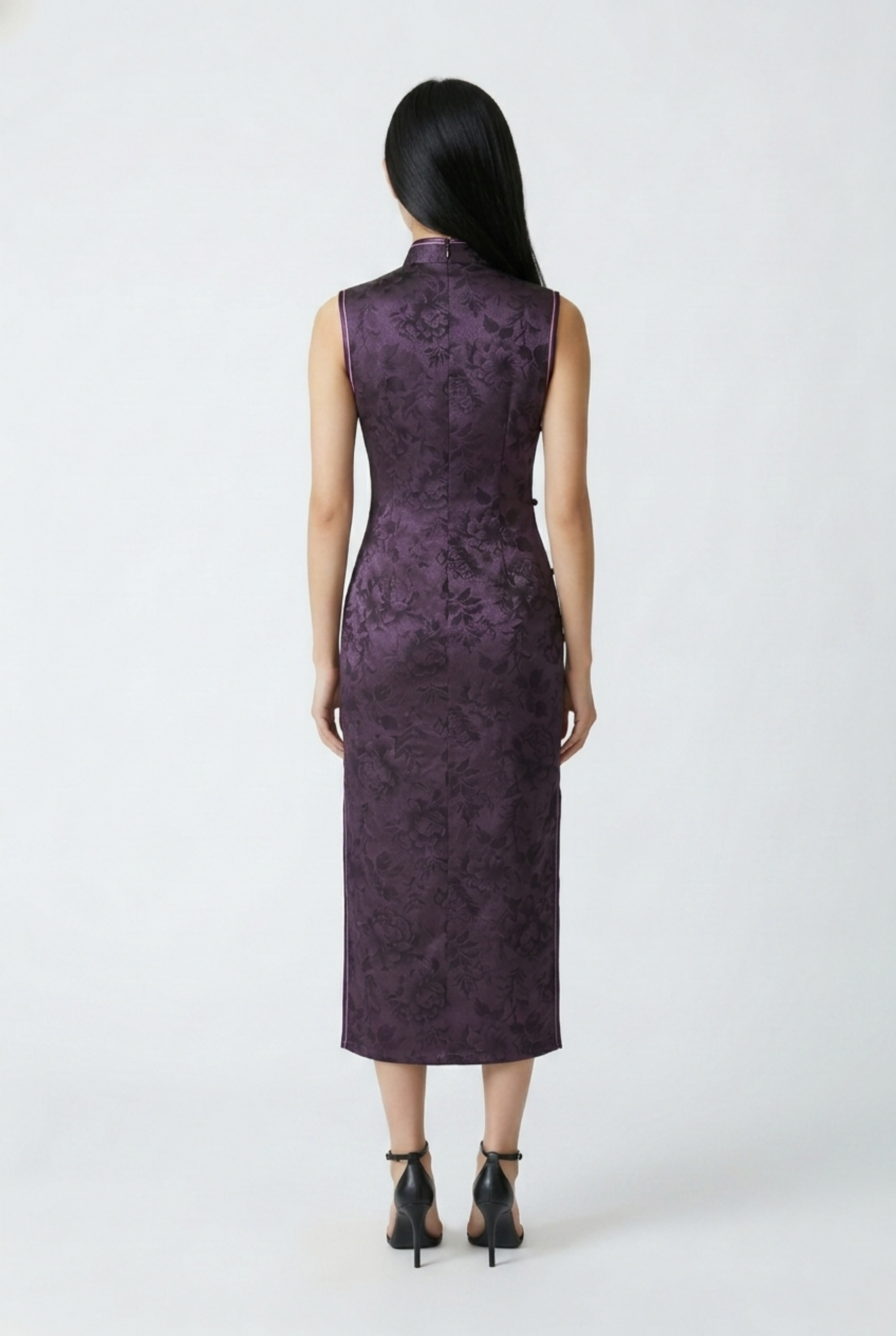 Full-length back view of the dark purple satin qipao dress showing the form-fitting midi silhouette and black heels