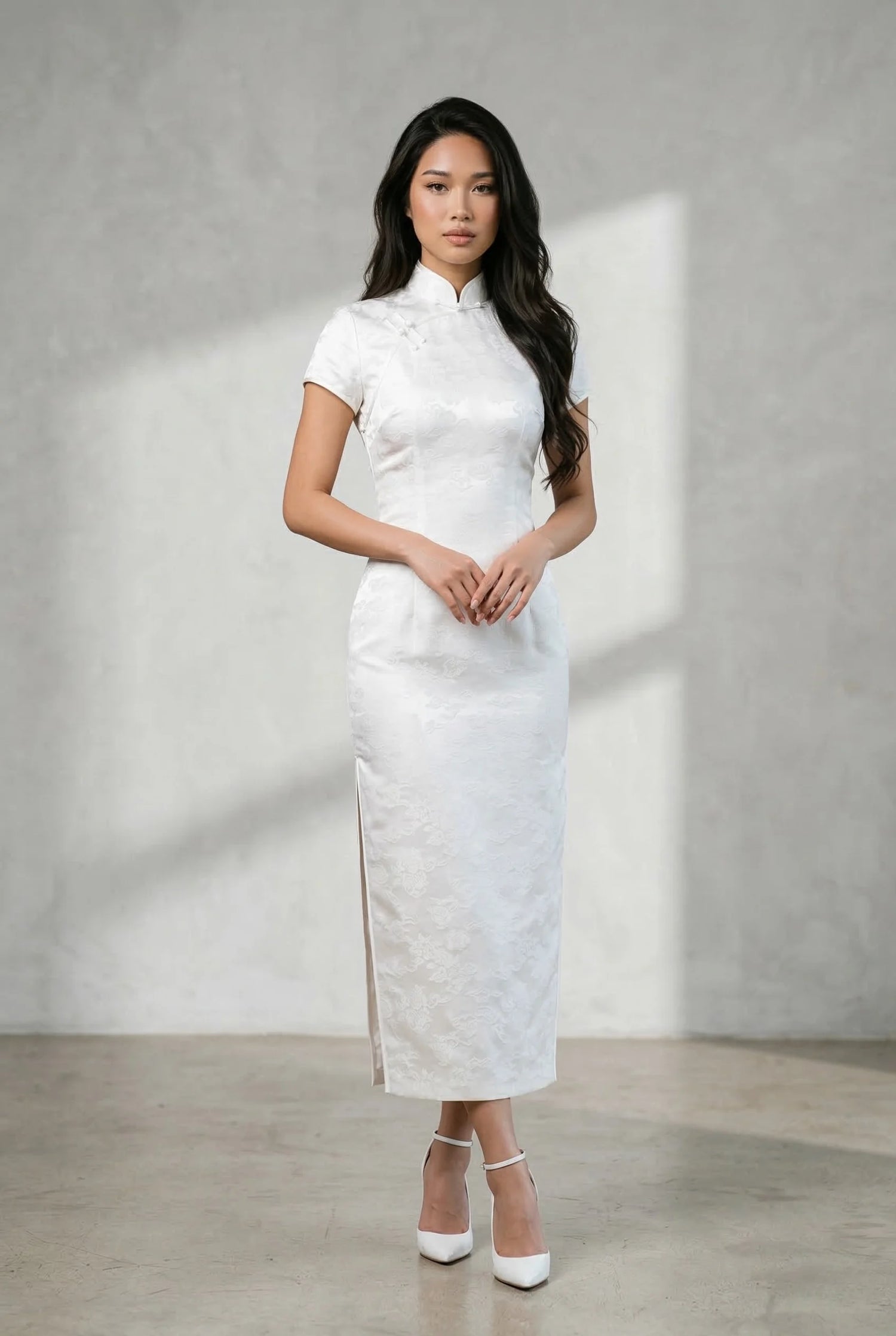 Full-length white qipao dress with subtle floral patterns, illustrating technical precision in tailoring for an iconic straight-line silhouette