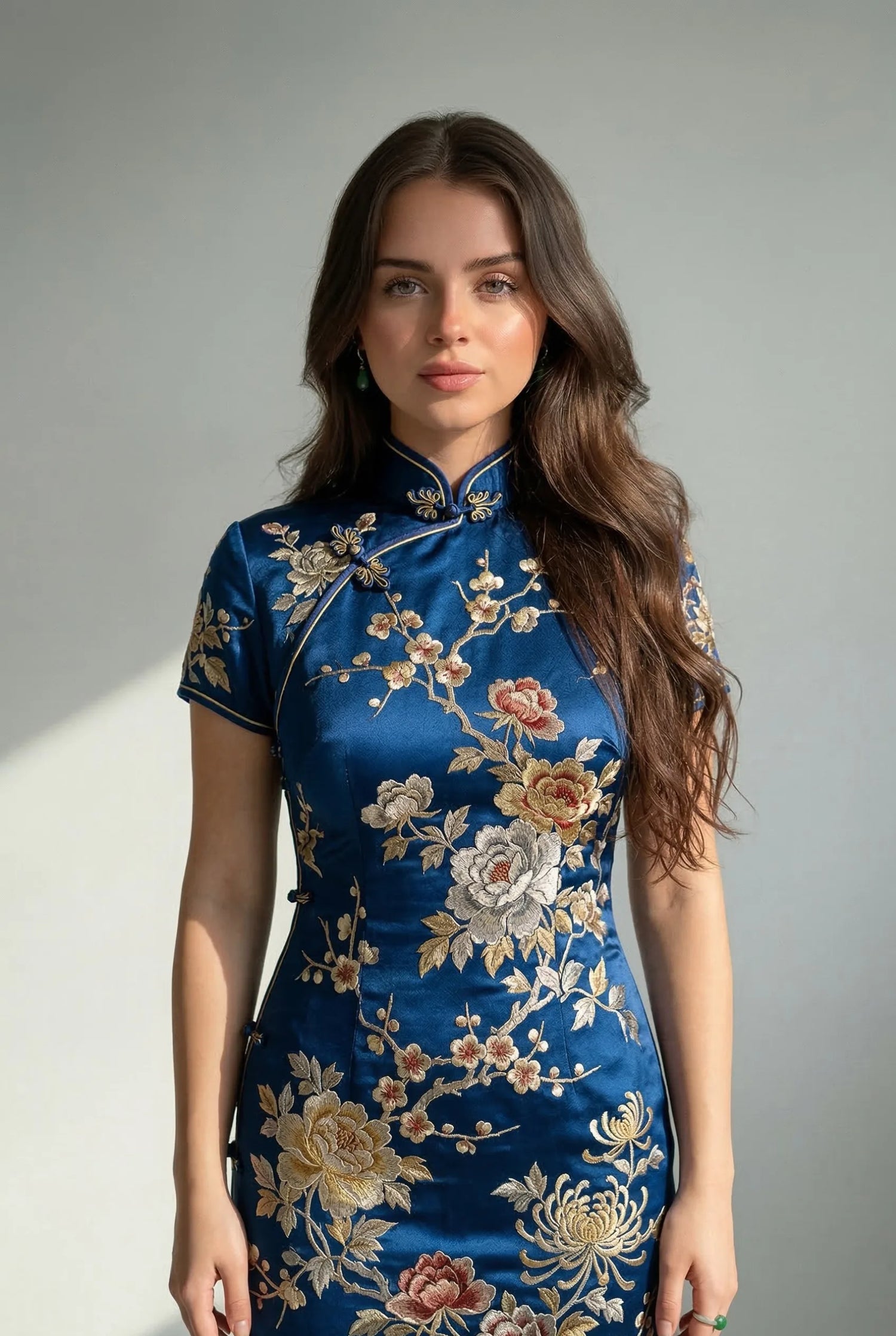 Vintage blue silk qipao with intricate gold and beige floral threadwork embroidery, reflecting traditional Chinese artistry and heritage textile standards