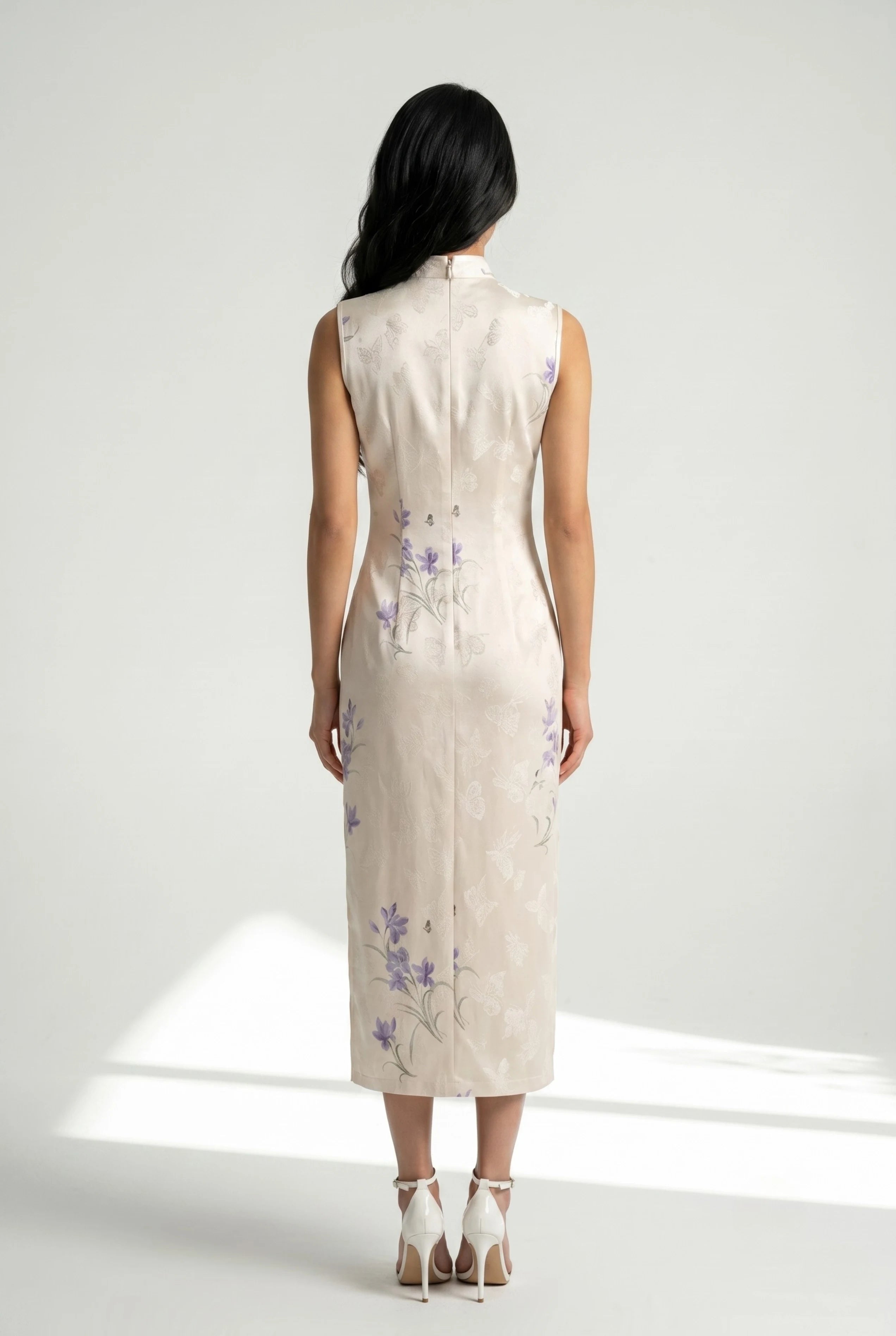 Full-length back view of the sleeveless white Chinese style dress showing the tailored midi silhouette and white heels