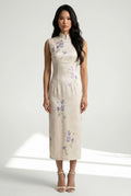 Front full-length view of a sleeveless white Chinese style dress with delicate purple floral patterns and white heels