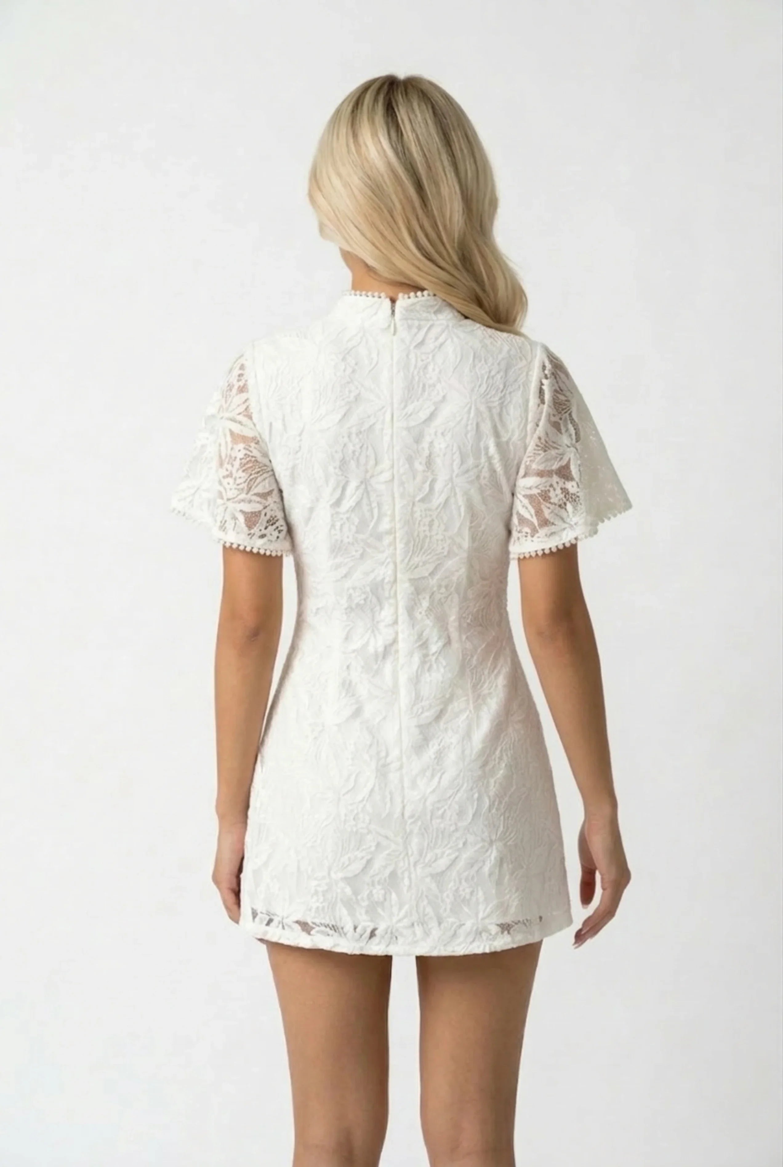 Back view of a form-fitting white lace Cheongsam playsuit showing the delicate lace pattern and high collar.