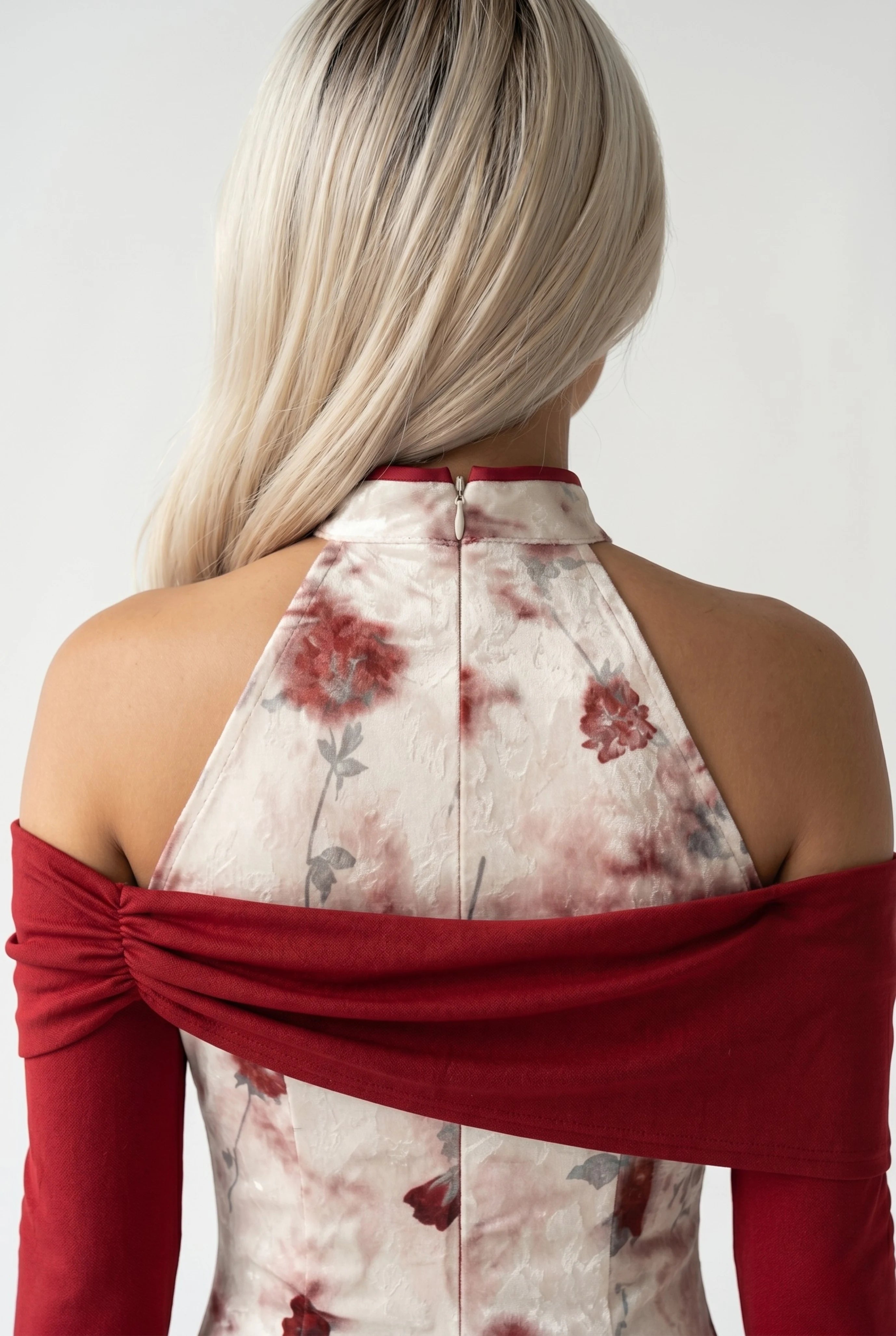 Close-up back view showing the halter-style back collar structure and the draped dark red fabric across the shoulders