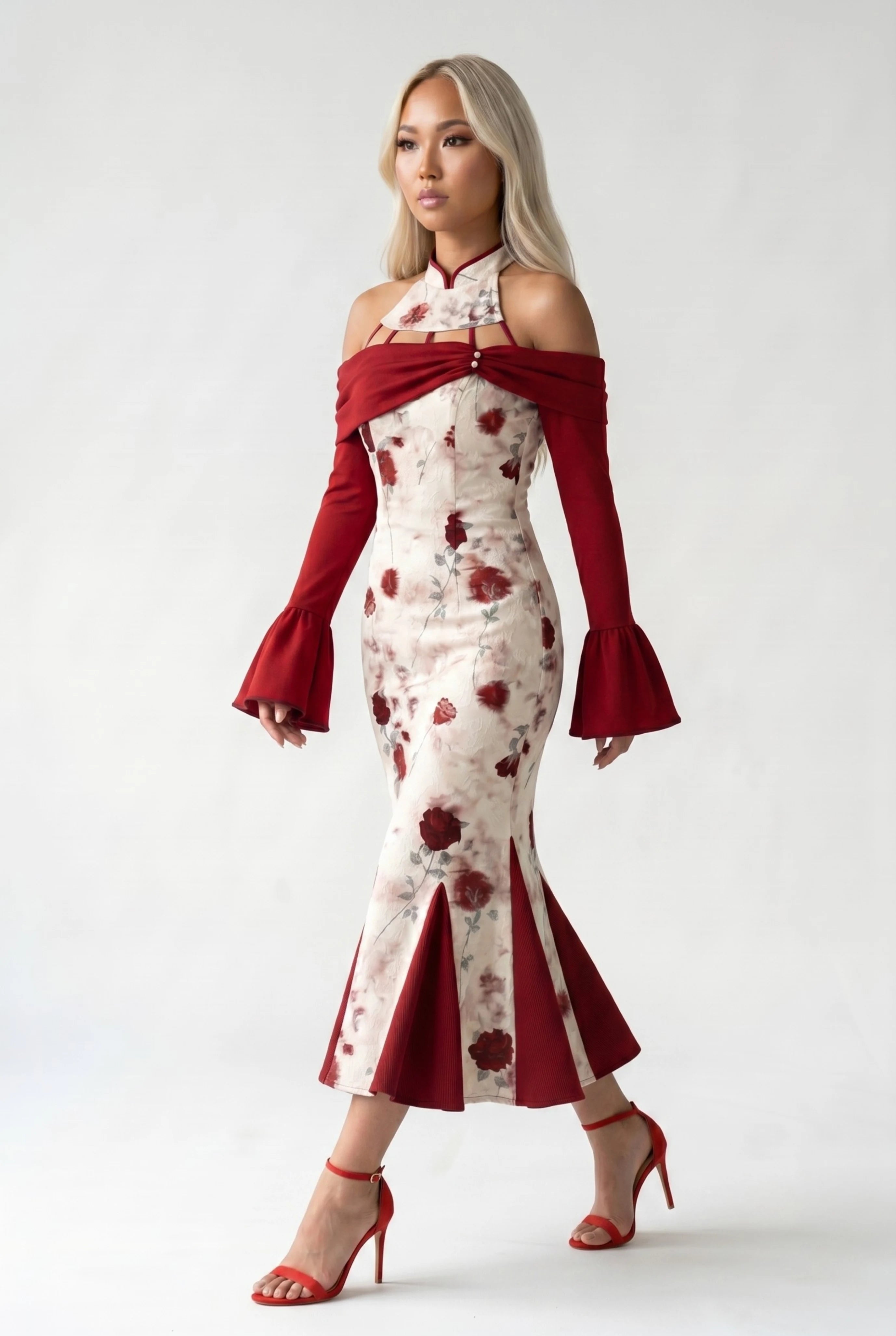 Side profile view of a woman walking in the white and red qipao, showcasing the elegant movement of the panel hem and bell sleeves