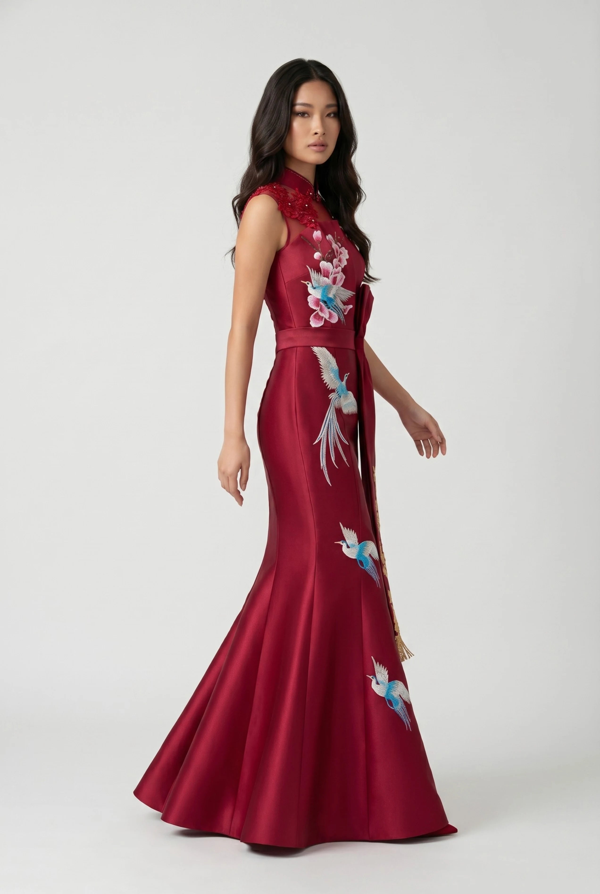Three-quarter side view highlighting the form-fitting design and floor-length flared hem of the red satin mermaid cheongsam