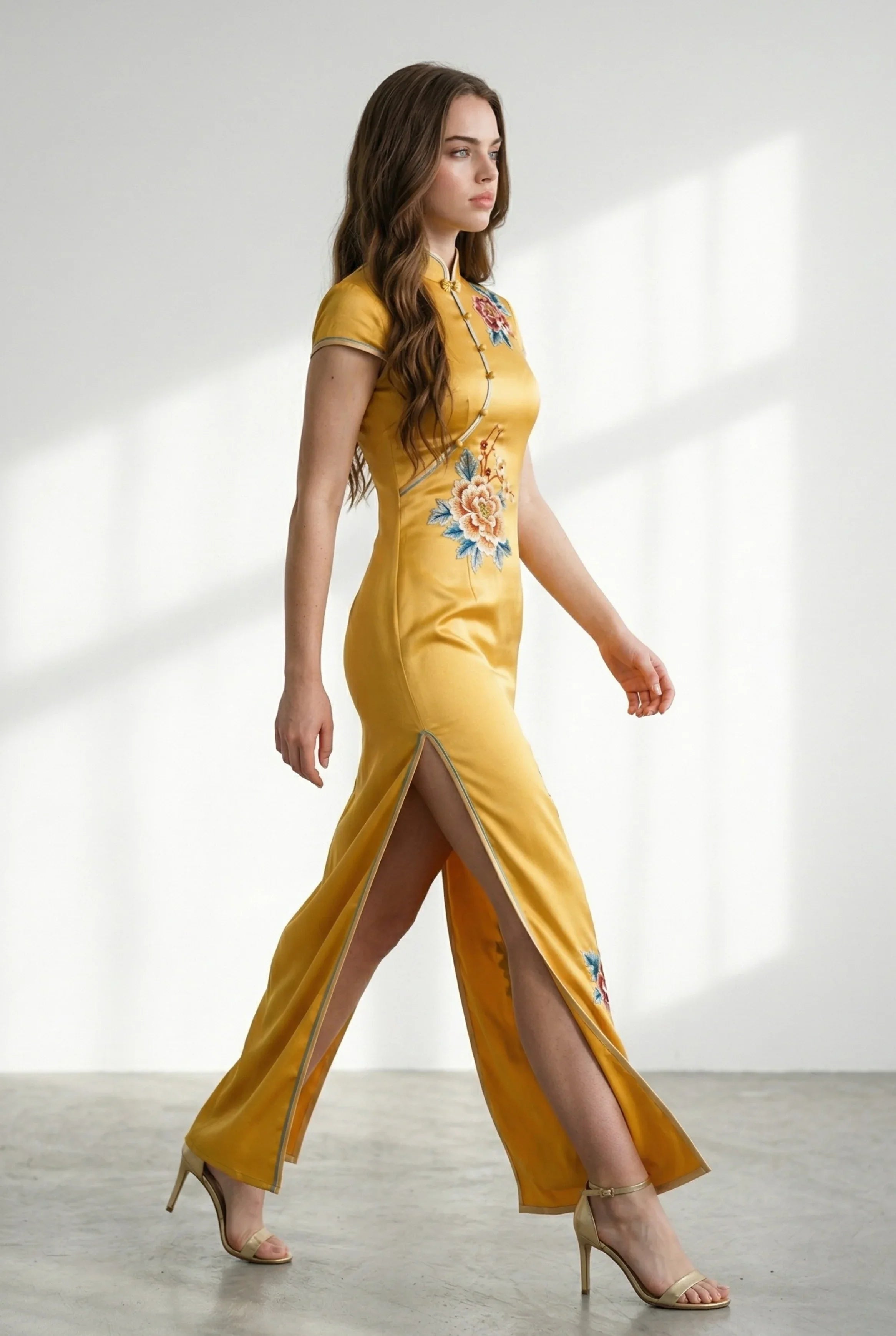 Side profile of the yellow cheongsam dress showing the high leg slit.