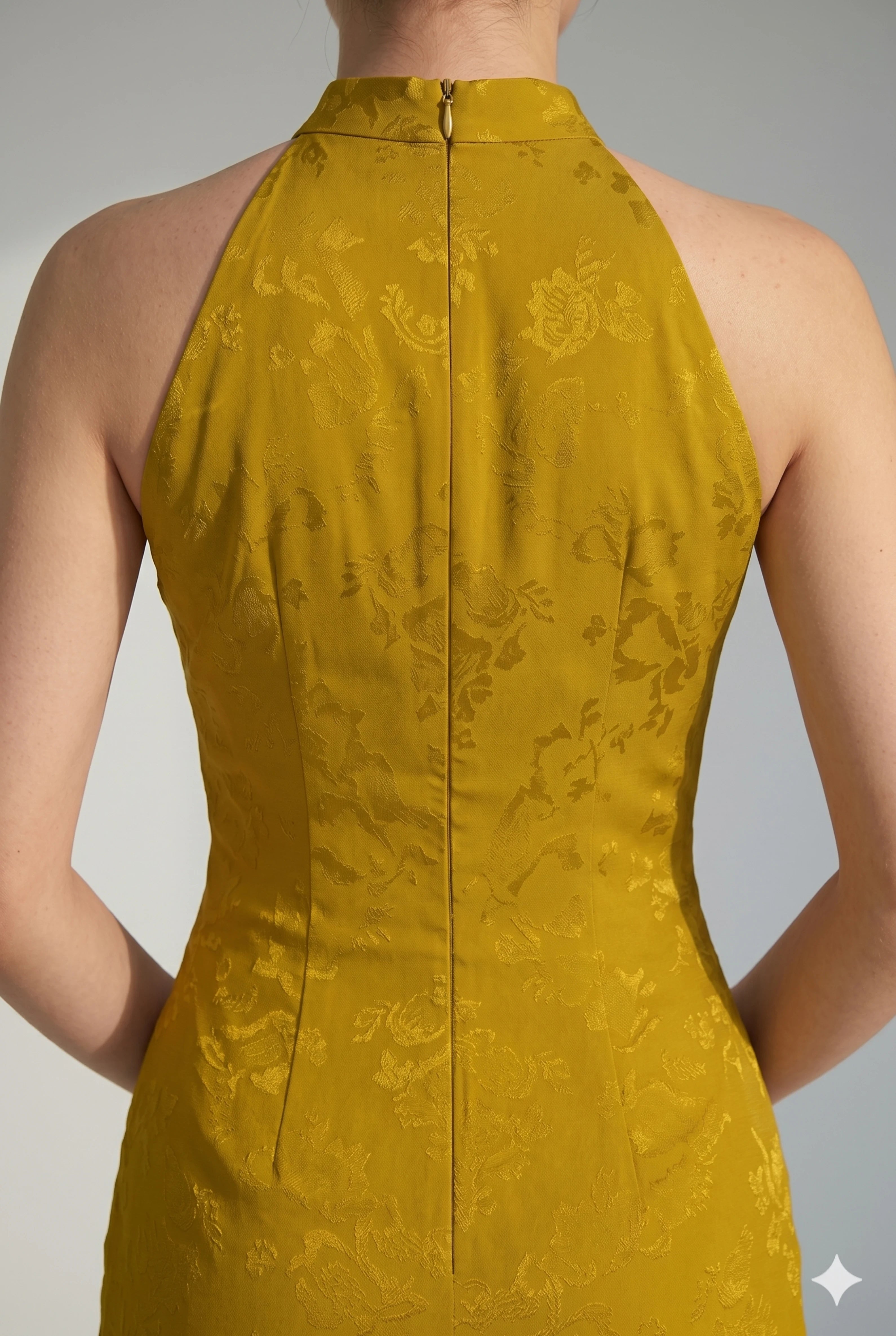 Close-up back view highlighting the halter neckline, zipper closure, and subtle floral jacquard fabric