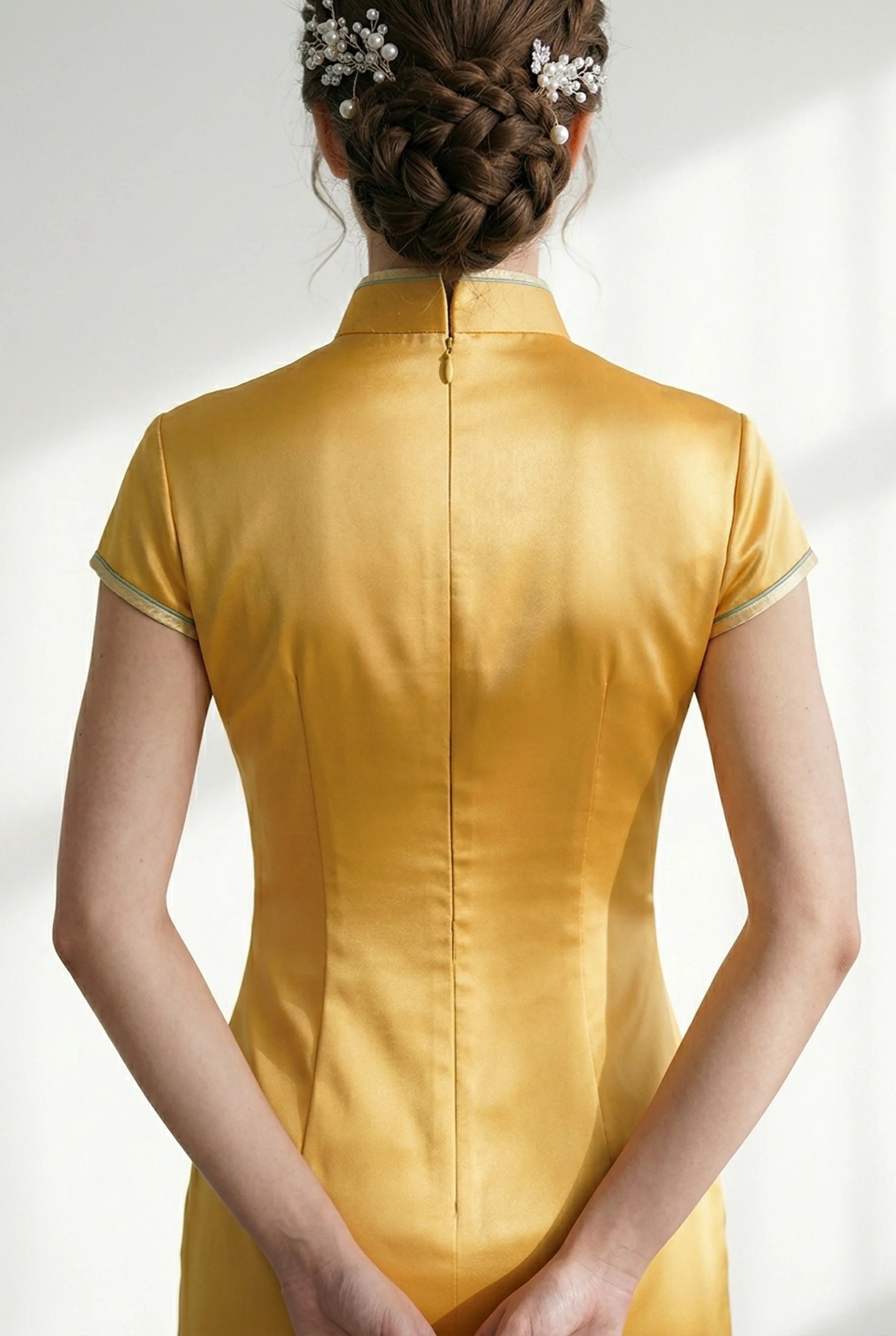 Close-up of the back of the yellow qipao showing the collar and zipper.