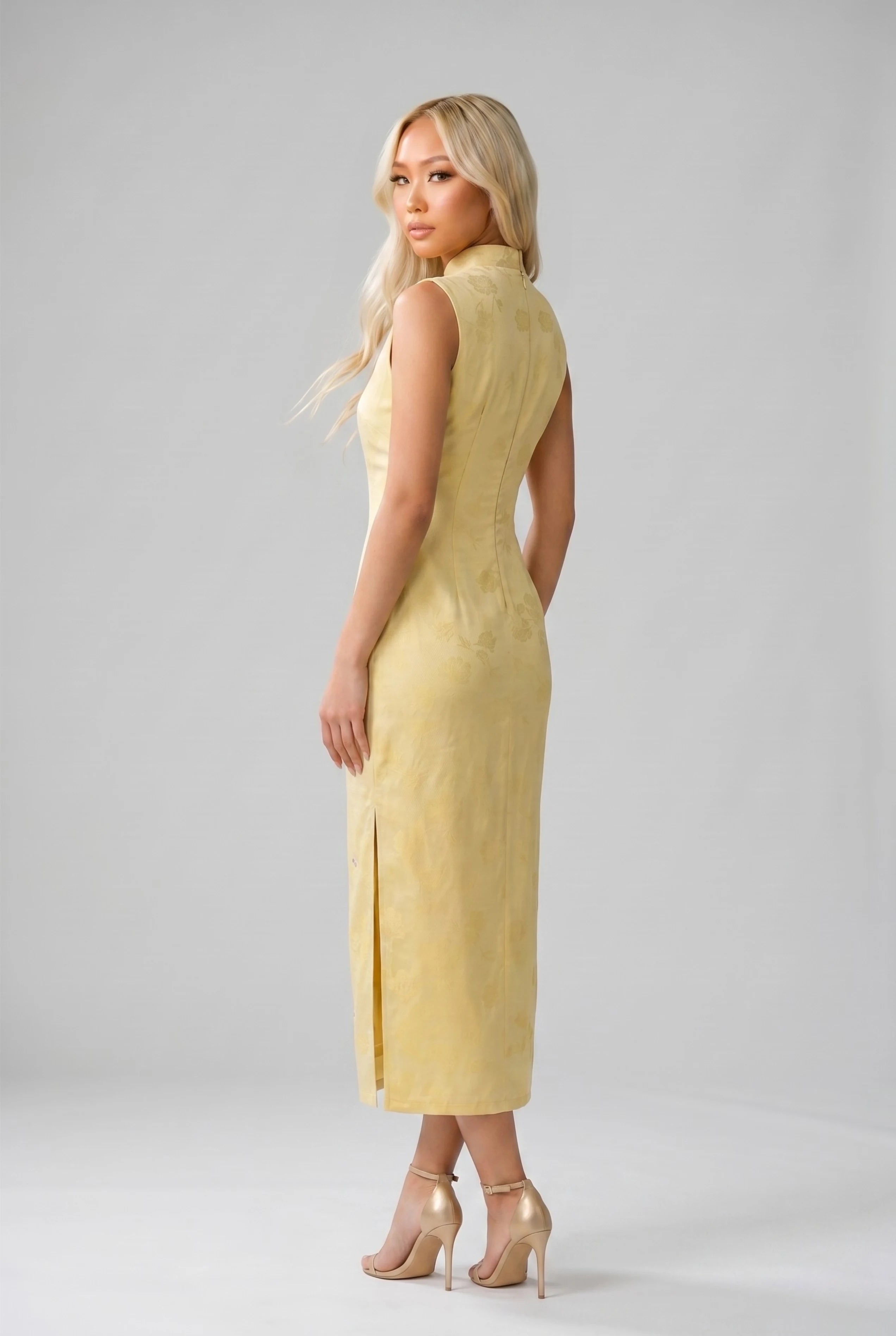Three-quarter back profile view highlighting the form-fitting design of the yellow qipao dress