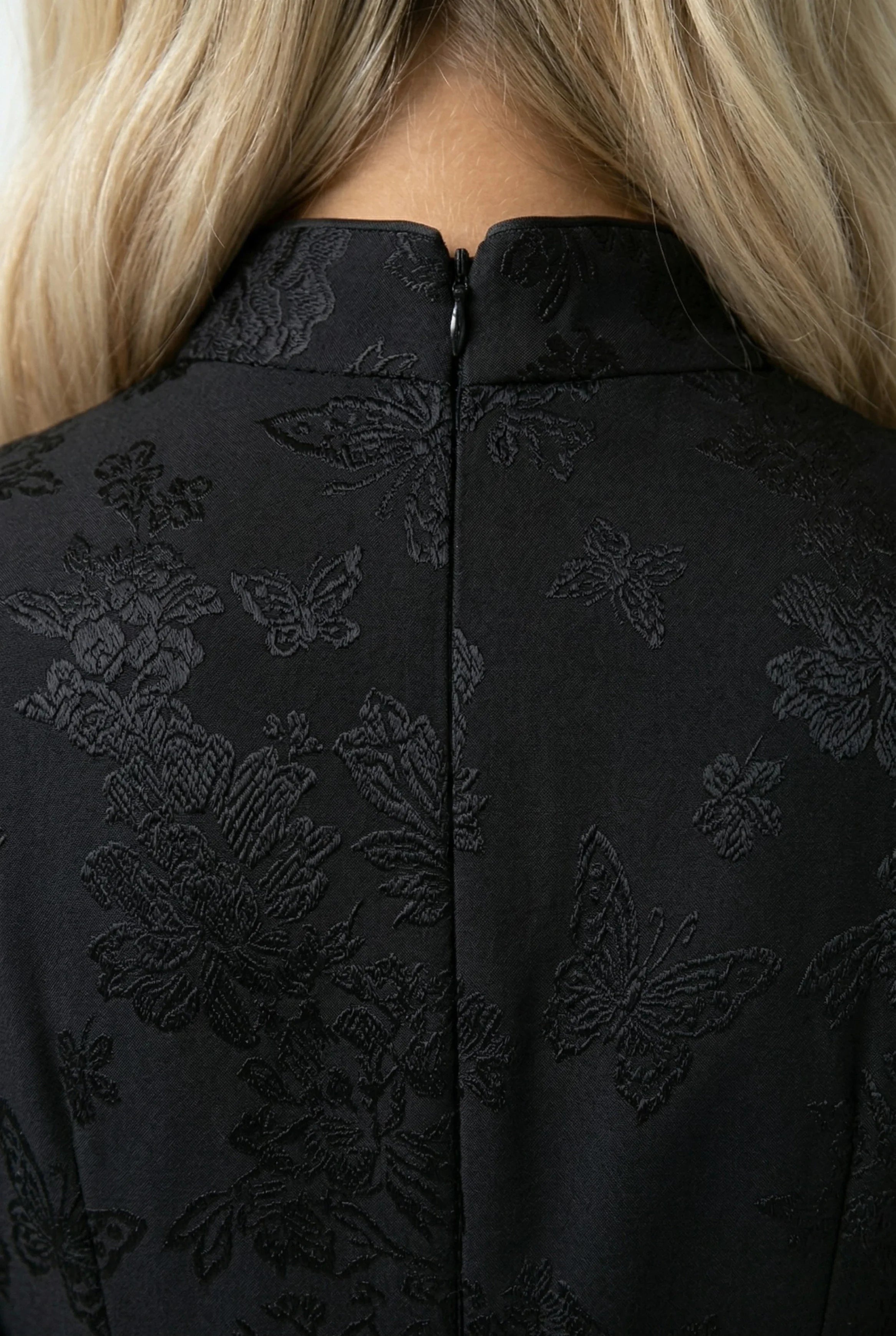 Close-up of the back of the black qipao collar with an invisible zipper.